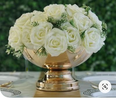 White rose arrangement in a gold pedestal vase