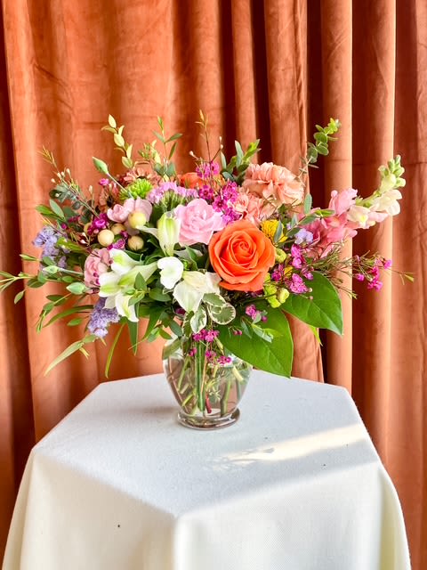 Golden Hour - Spring Joy is a designer's choice arrangement that captures the untamed beauty of a wildflower field. Featuring seasonal blooms in vibrant cheerful tones, each design is one-of-a-kind - perfect for brightening someone's day or celebrating life's joyful moments. While specific flowers may vary with the season, the lively spirit and springful palette will always shine through.