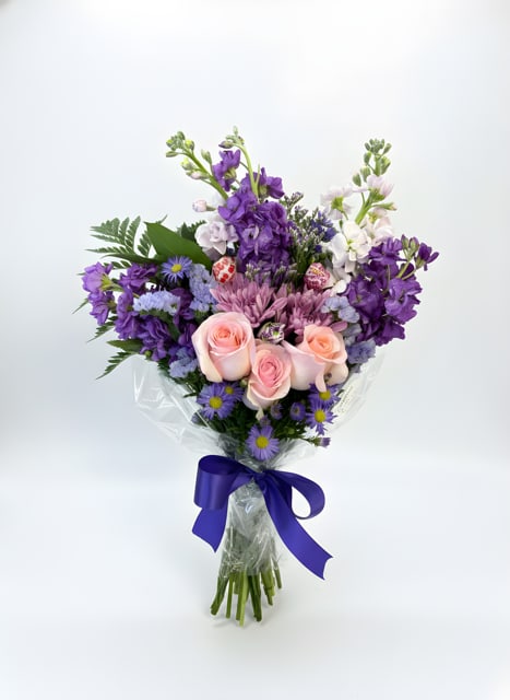 Milestone Magic Bouquet - Celebrate life's sweetest moments with a bouquet designed especially for your little one! Perfect for birthdays, dance recitals, graduations, sports achievements, school milestones, and more. Each bouquet is created in our designer's choice style using a cheerful mix of seasonal flowers and colors, complete with complimentary glitter for an extra touch of magic.  Please note: The photo shown is a sample. Each bouquet is uniquely designed, and flower varieties, colors, and overall style will vary based on seasonal availability and the designer's selection.