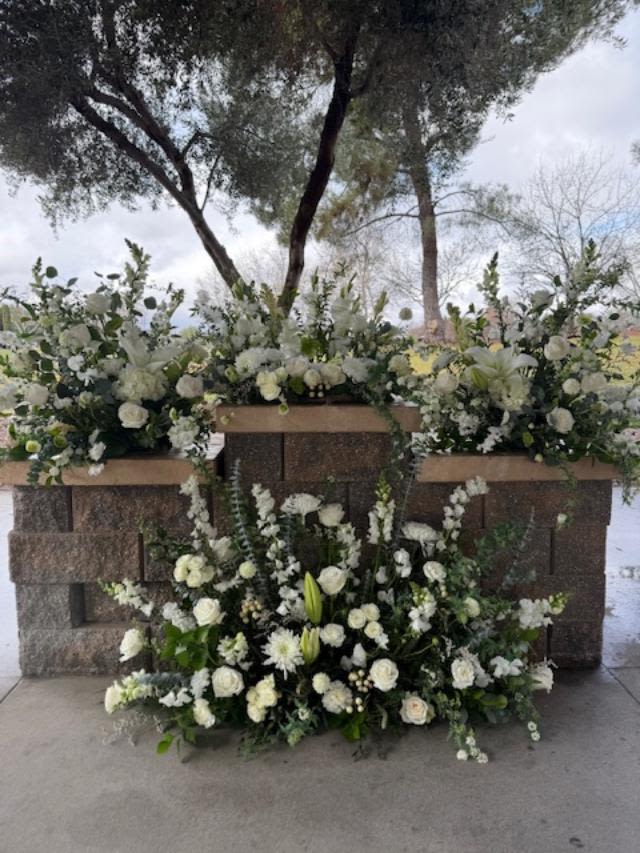 Premium Full Service Set - Four sympathy pieces designed specifically for Riverside National Cemetery services. The middle piece has space in the middle for an urn/box. In addition you will get 2 matching pieces for the side columns and one long floor piece. All pieces will be done in seasonal white and cream flowers with greenery unless otherwise requested. *Please leave color requests in special instructions*