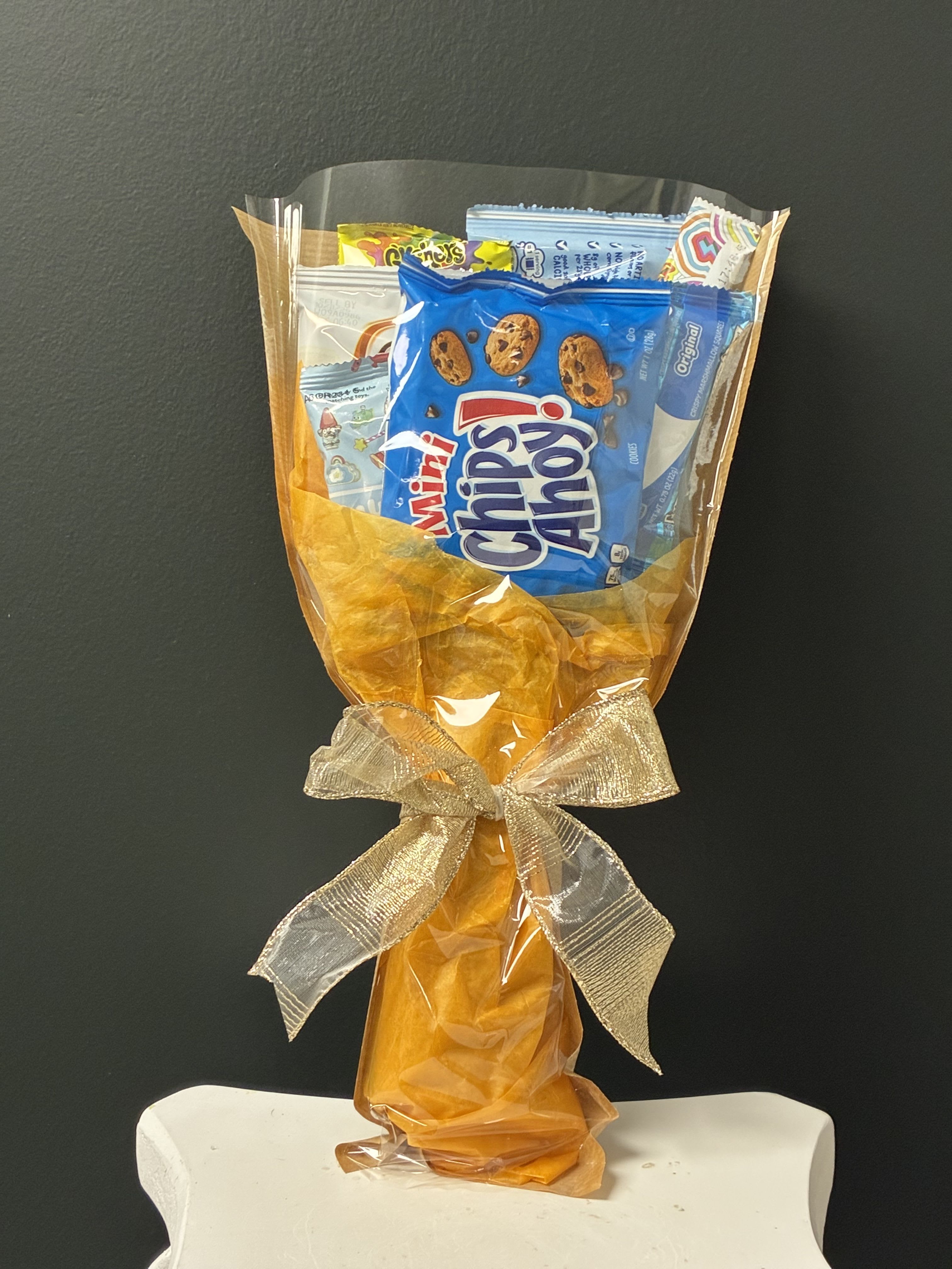 Snack Bouquet - A fun and colorful arrangement filled with kid-favorite snacks and sweet treats! Perfect for birthdays, celebrations, get-well gifts, good report cards, or just because. Each bouquet is thoughtfully designed to bring big smiles and delicious surprises, making it a gift that's both exciting and memorable.  Snacks may vary, making every bouquet truly unique.