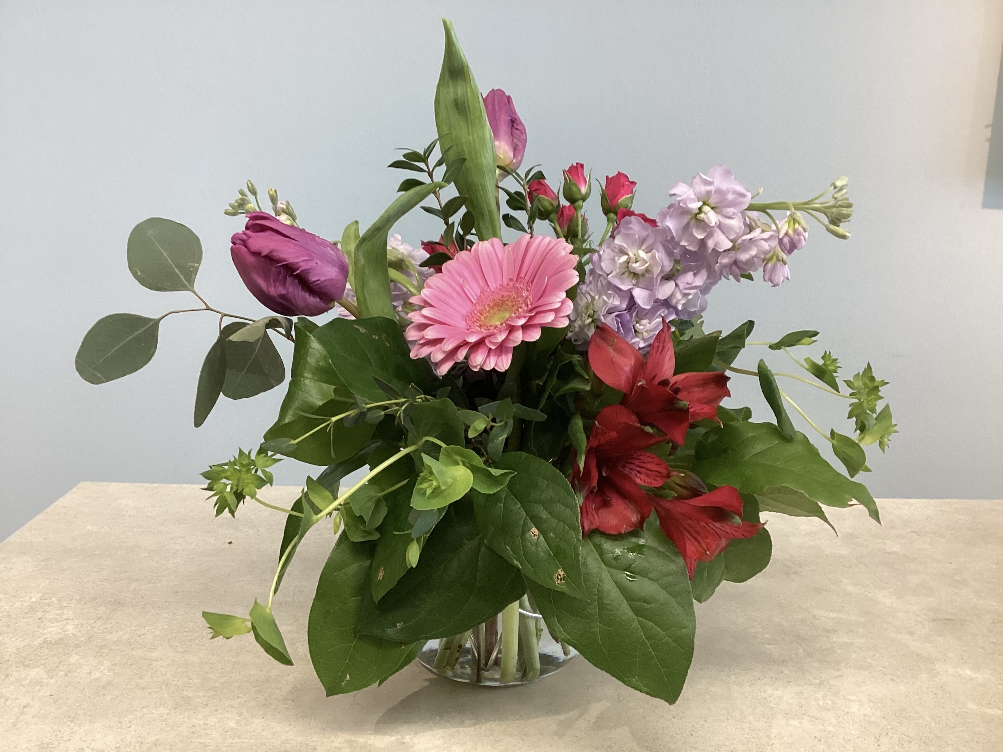 $75 Designer's Choice - Wanting something unique? Allow our designers to create a beautiful arrangement for you! This medium-sized arrangement will include our best product. Feel free to include a preference if you have one, and we will do our best to accommodate you. Please keep in mind that we won't always have every flower in stock!