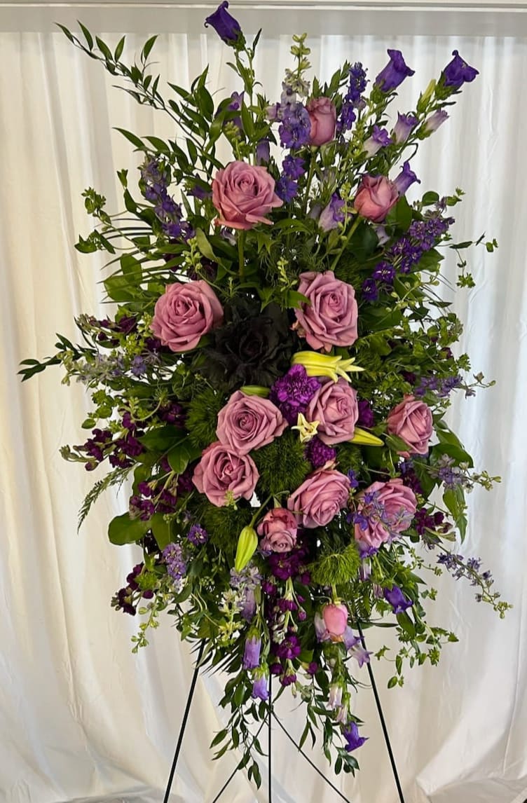 Tall standing floral spray with pink roses and purple blooms