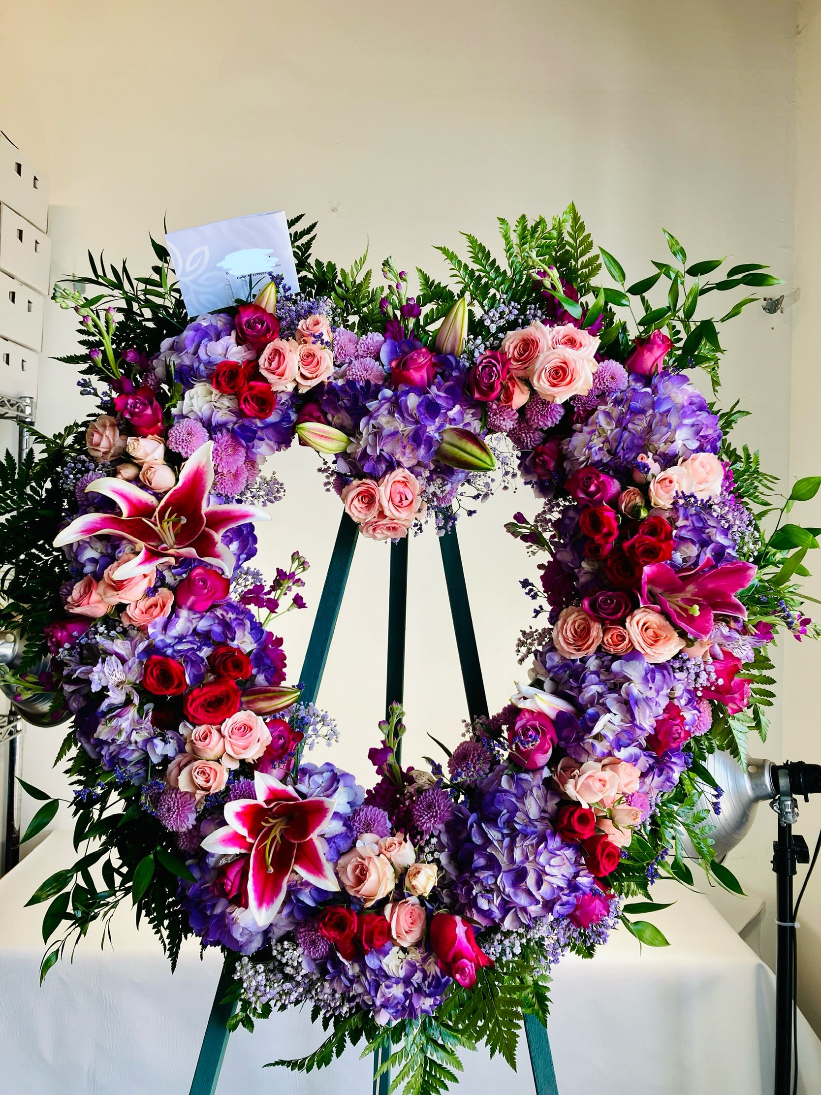 Heart-shaped floral wreath with pink, purple, and red blooms