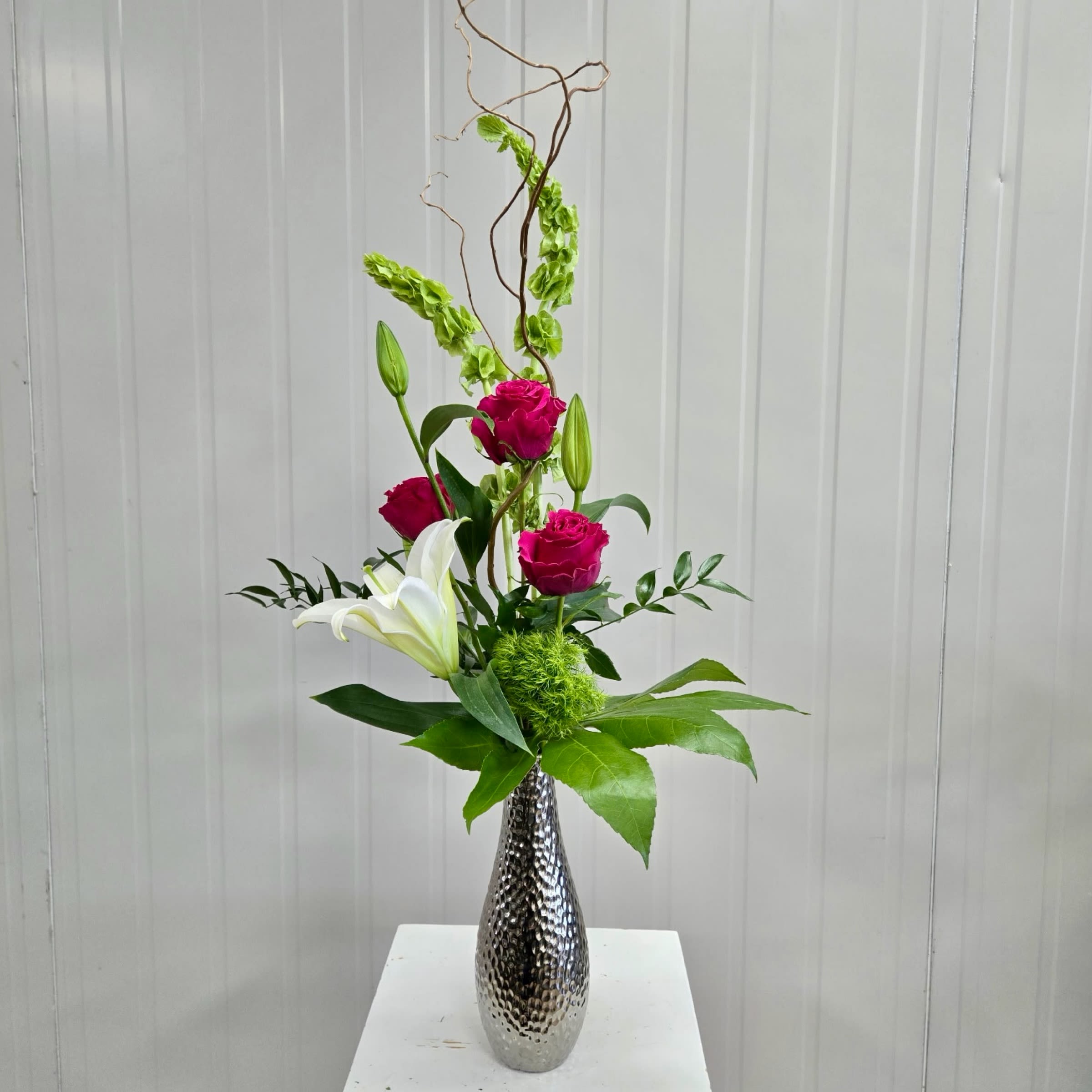 Sweet Sterling - This Silver Bud Vase Includes Hot Pink Roses. Bells of Ireland, White Lily, Green Trix and Curly Willow. Or as Similar as Possible. 