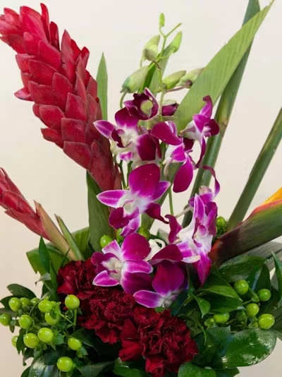 Designer's Choice Short Tropical - A vibrant, compact showcase of island‑inspired beauty, our Designer’s Choice Tropical Short Arrangement highlights the rich colors and bold textures of premium tropical blooms. Each piece is thoughtfully designed with a curated