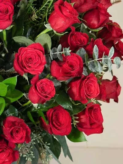 Designer's Choice Romance Tall - A striking, sculptural expression of passion, our Designer’s Choice Romance Tall Arrangement is designed in a luxurious palette of rich jewel tones. Deep purples, velvety burgundies, and romantic reds are artfully combined using premium seasonal blooms chosen fresh by our designer for height, texture, and emotional depth.  Arranged in an elongated, graceful silhouette, this piece radiates dramatic elegance — full, moody, and undeniably romantic. Perfect for anniversaries, grand gestures, or creating a captivating focal point in any space where love deserves to be seen and felt