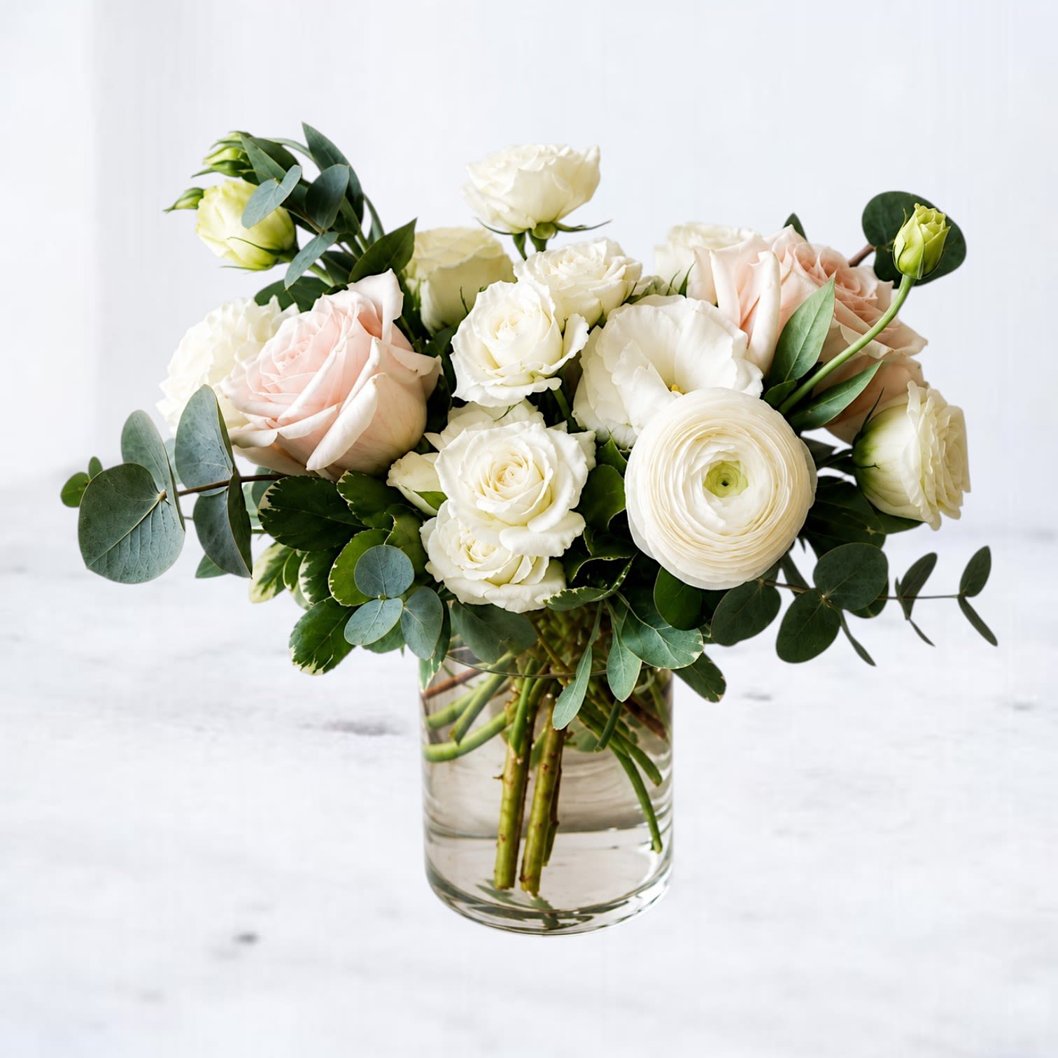 Cream &amp; Calm - When words feel too heavy, Cream &amp; Calm speaks for you with grace and quiet beauty. This tender arrangement features creamy white roses, blush-toned blooms, soft ranunculus, and silvery eucalyptus in a clean glass vase—an elegant gesture of apology, reflection, or healing. Understated and heartfelt, it offers comfort and sincerity with every petal.  Whiskey Wallflower is a design-forward florist serving Magnolia, The Woodlands, Montgomery, Willis, Conroe, Spring, Tomball and surrounding Houston-area communities. We specialize in thoughtfully composed, modern floral arrangements with a focus on premium blooms, intentional design, and reliable same-day delivery. Every piece is created with care to make life’s moments feel elevated, personal, and unforgettable.