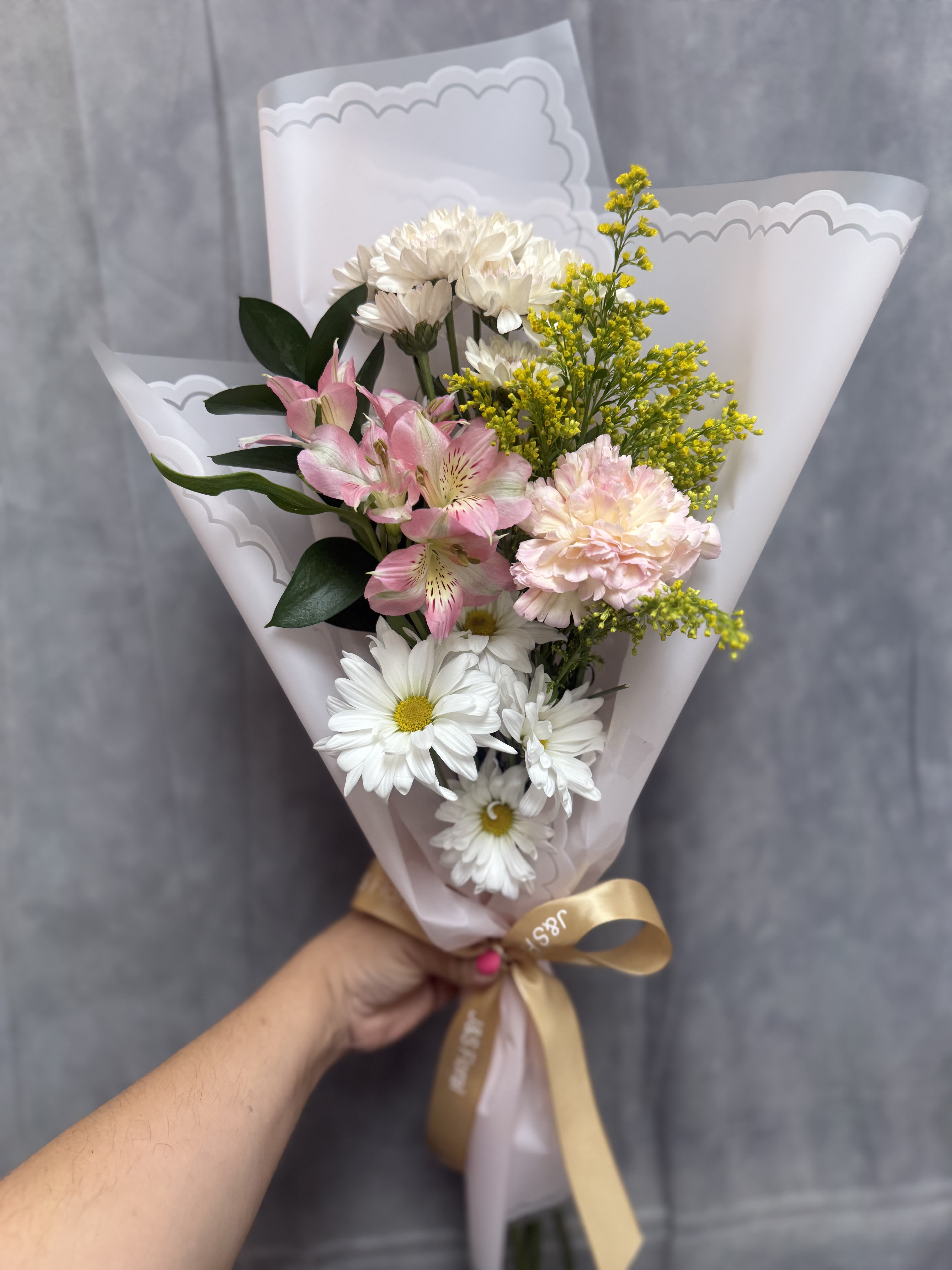 Blush daydream bouquet  - Pink and white daisies with a pink carnation and purple accents, wrapped in lavender mesh with white ribbon-fresh, cheerful bouquet perfect for birthdays, thank-yous, or Mother's Day.