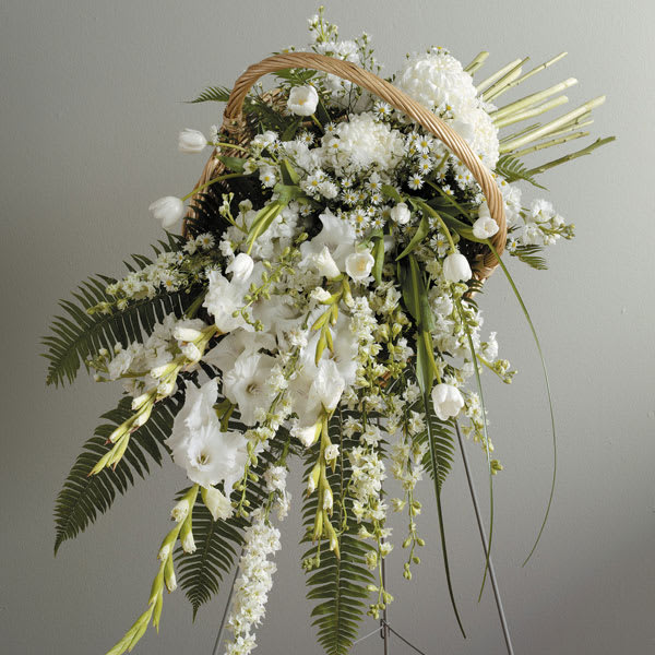 Fireside Basket Standing Spray - A contemporary tribute, combining the warmth of a fireside basket with the drama of an easel display. Featuring gladiolus, larkspur, football mums, tulips and more.