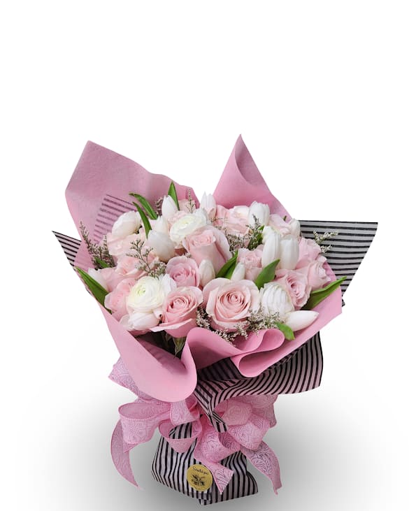 Bouquet of pink and white roses with white tulips wrapped in pink paper