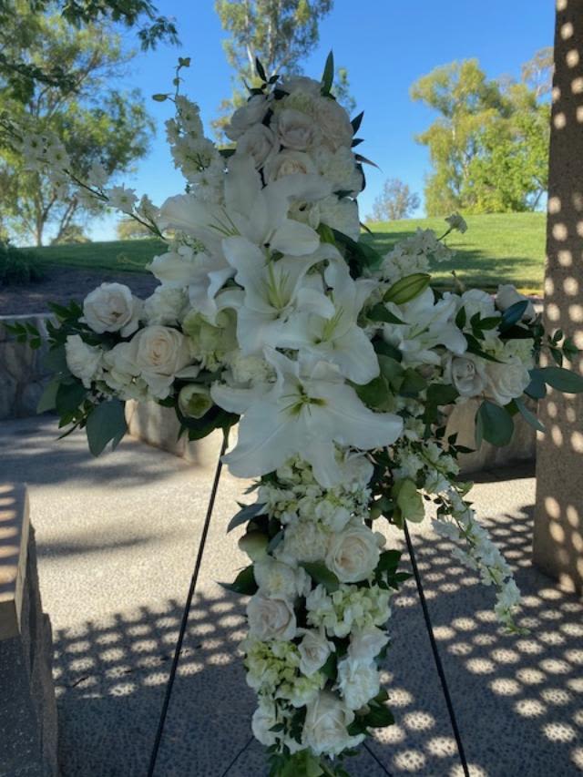 Serenity Cross  - A traditional floral cross- all white mixed flowers designed with a cross spray of lilies an roses. 