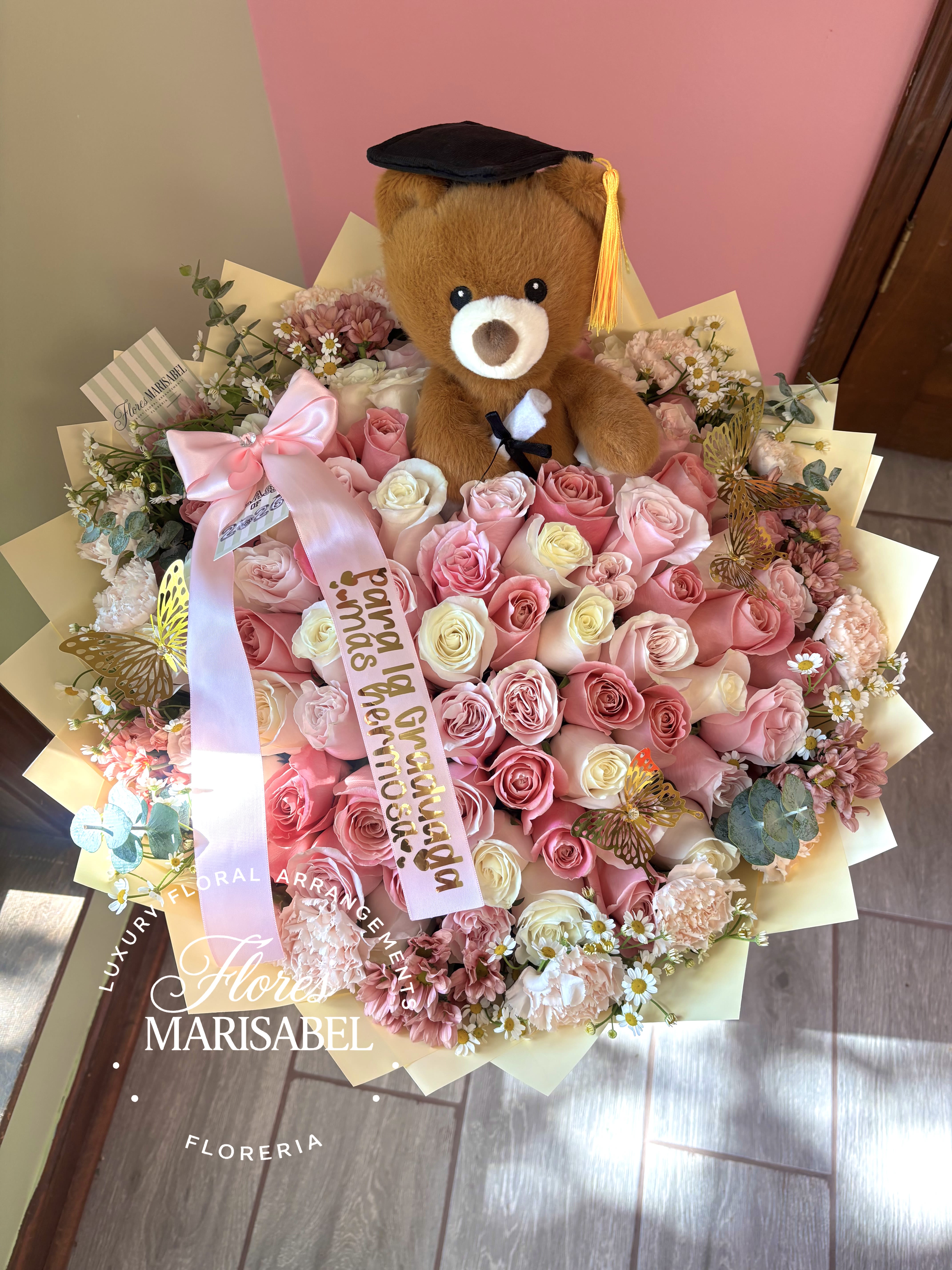 75 rose graduation bouquet  - 75 roses. Includes grad bear, custom ribbon phrase, flower rim (flowers will vary) 4 butterflies 