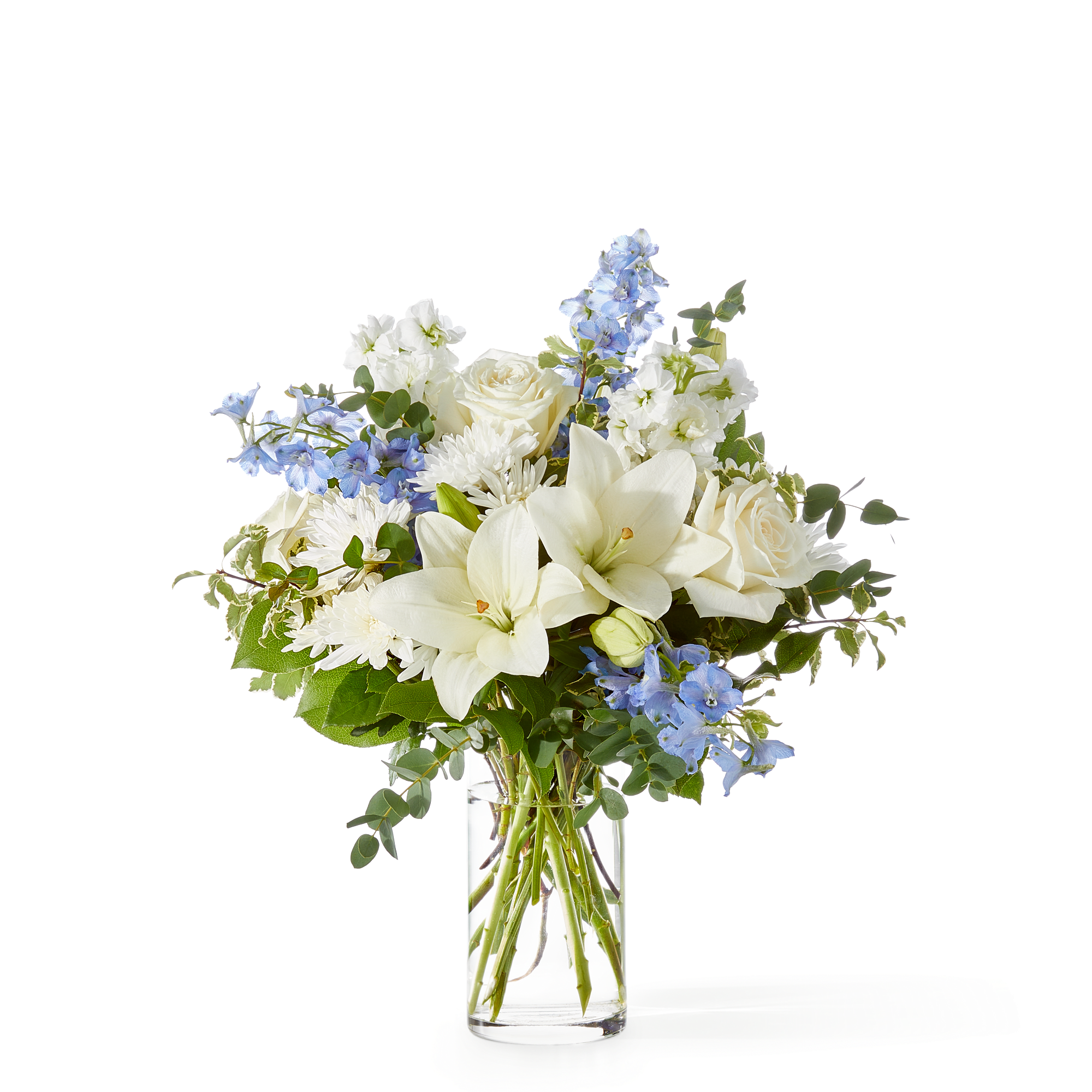 Peace of Mind Bouquet - An elegant blend of white lilies, roses, and chrysanthemums accented with soft blue delphinium and fresh eucalyptus. Serene, timeless, and beautifully balanced—perfect for expressing sympathy, offering comfort, or bringing a peaceful touch to any space.