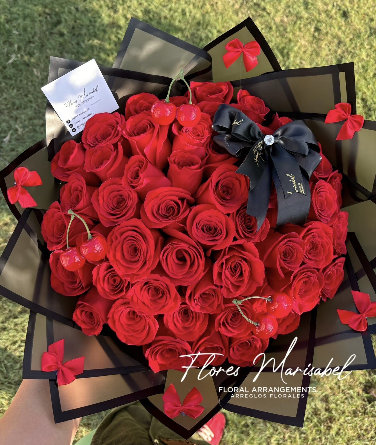 La cherry 50 roses  - 50 red roses. Cherries and bows. Black or green wrap  Please leave in florist instructions preferred paper color. 
