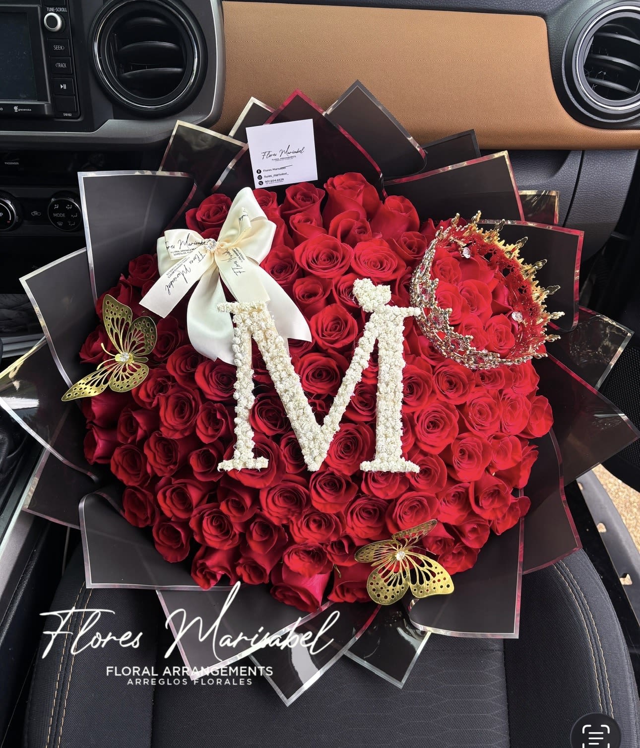 100 roses with initial  - 100 red roses. Initial. Black paper. (Does not include crown or butterflies.) *Put desired initial in florist instructions. 