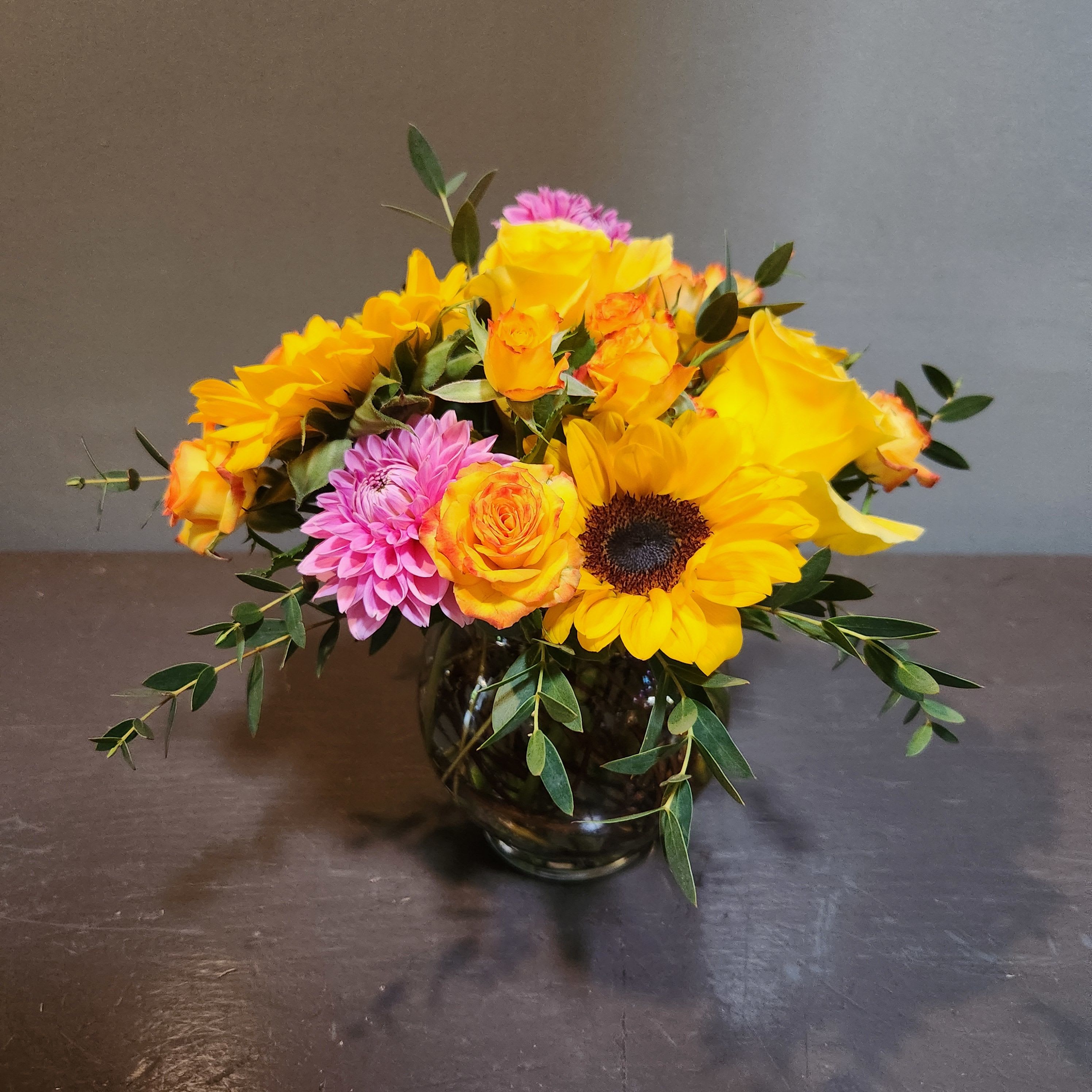 A Little Pop of Sunshine - A bright pop of fresh flowers to brighten your day.  Measures approx. 10"Tx9"W and arrives in a glass cube vase.