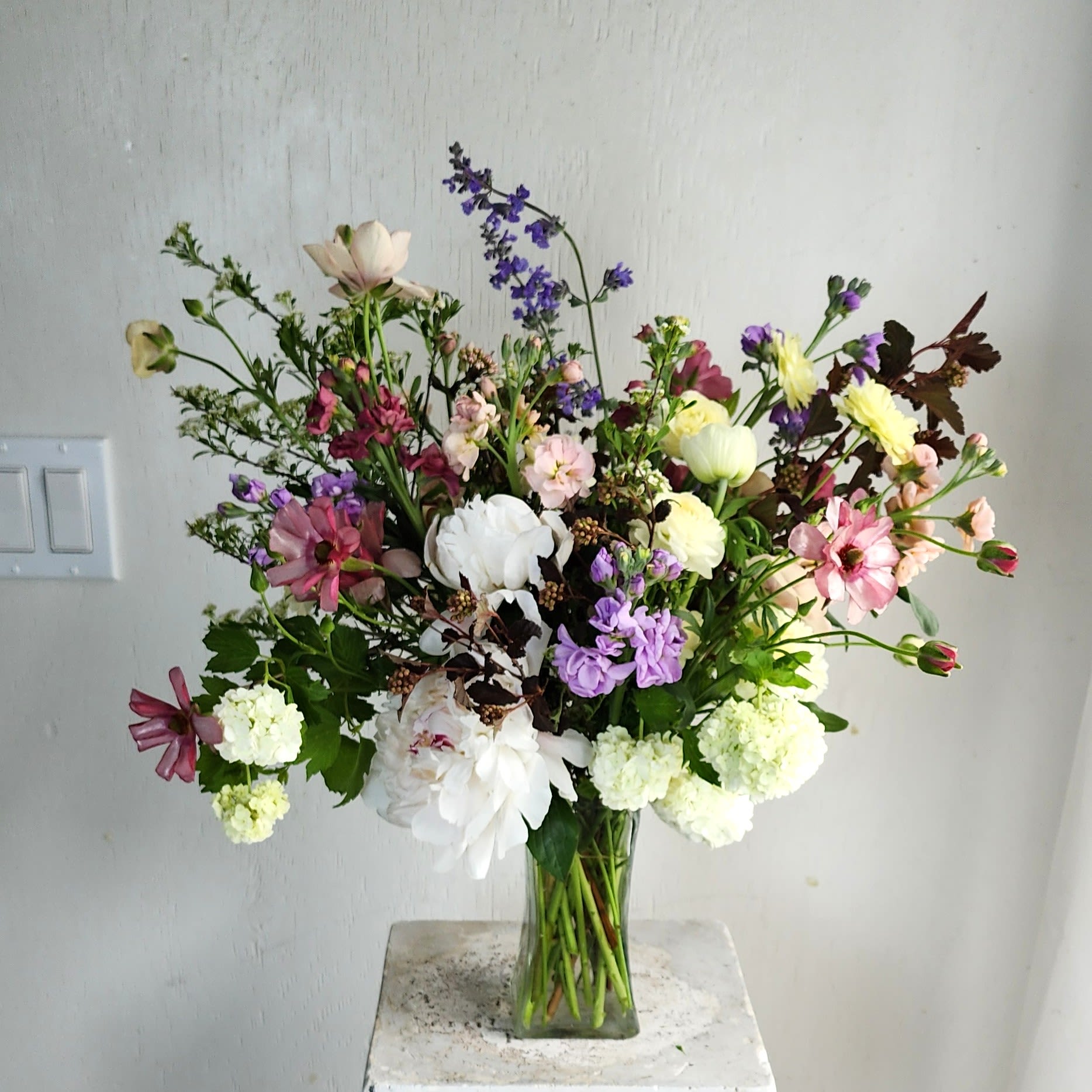 Spring Abundance (Designers Choice) - We are a small studio florist in a small town. Every bouquet we create is a one-of-a-kind creation available. The photos do not represent the exact flowers that will be delivered. They are intended to provide you with an idea of  the variance that can be expected.  The season, availability of flowers,interpretation, and the current materials available. 