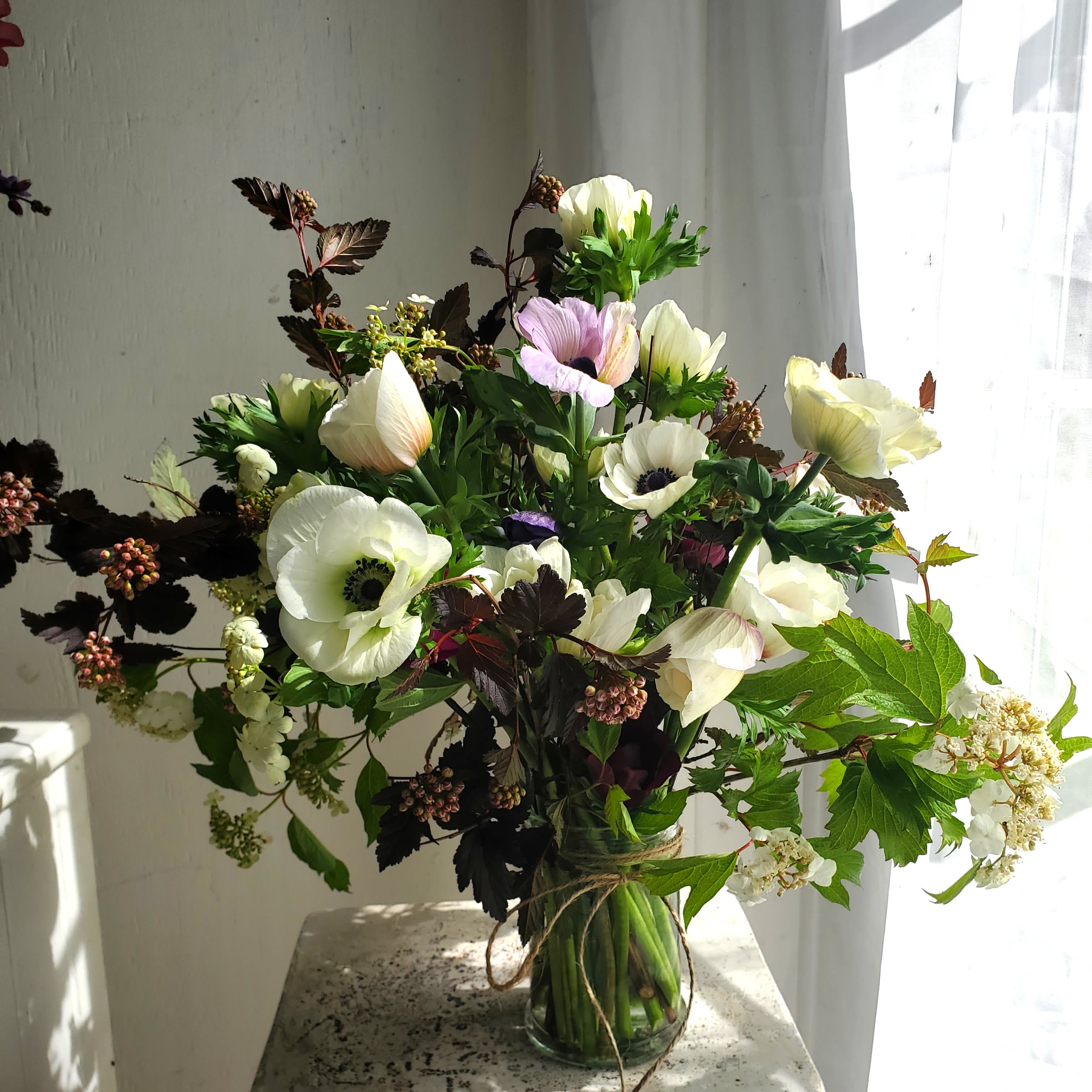 Classy Whites (Designers Choice) - We are a small studio florist in a small town. Every bouquet we create is a one-of-a-kind creation available. The photos do not represent the exact flowers that will be delivered. They are intended to provide you with an idea of  the variance that can be expected.  The season, availability of flowers,interpretation, and the current materials available. 