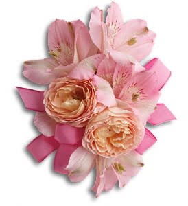 Pink and peach floral corsage with ribbon accents