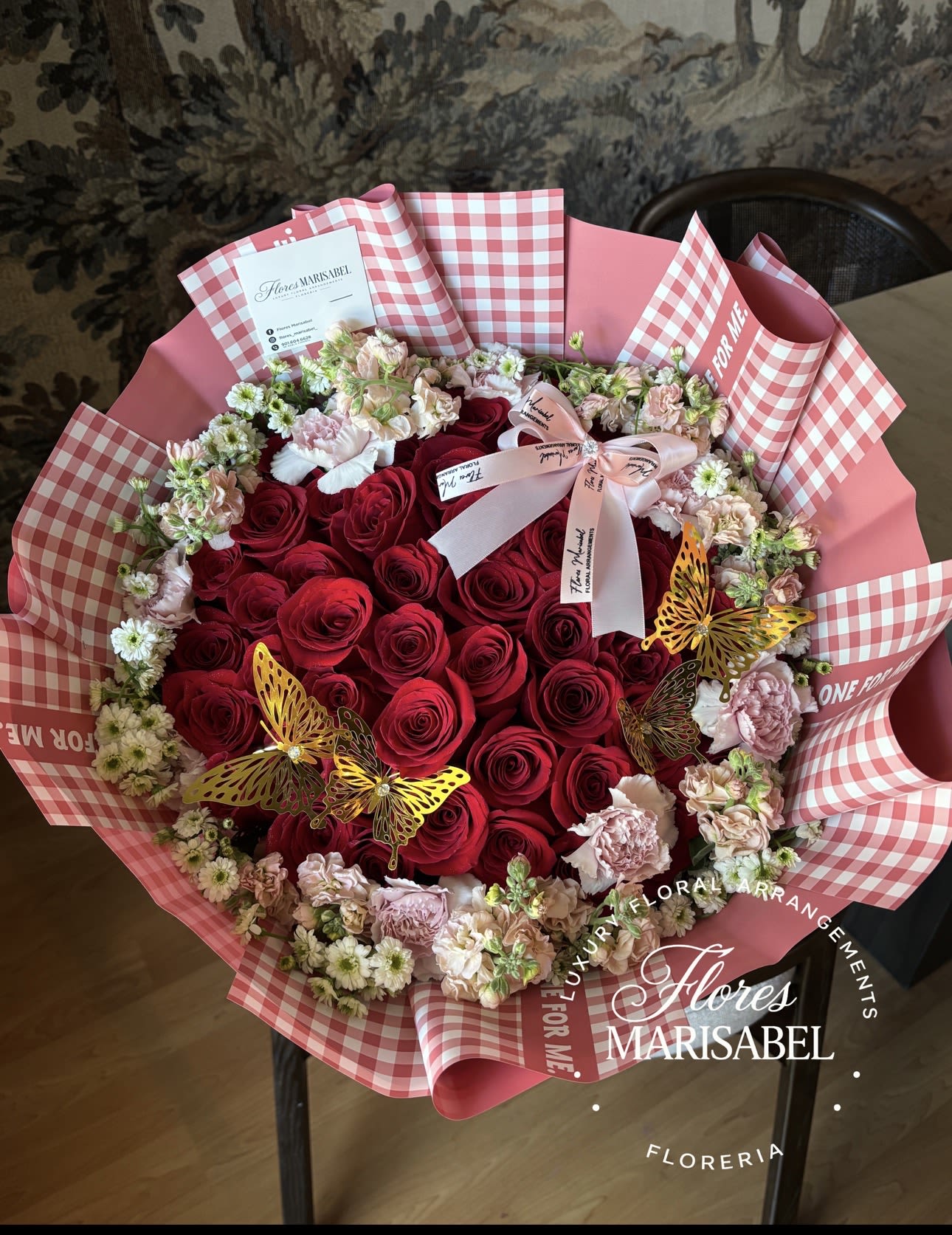 Lolita  - 50 red roses with flower rim (flowers will vary)  If plaid paper is out of stock  we will replace with something that matches.  (Butterflies not included) 
