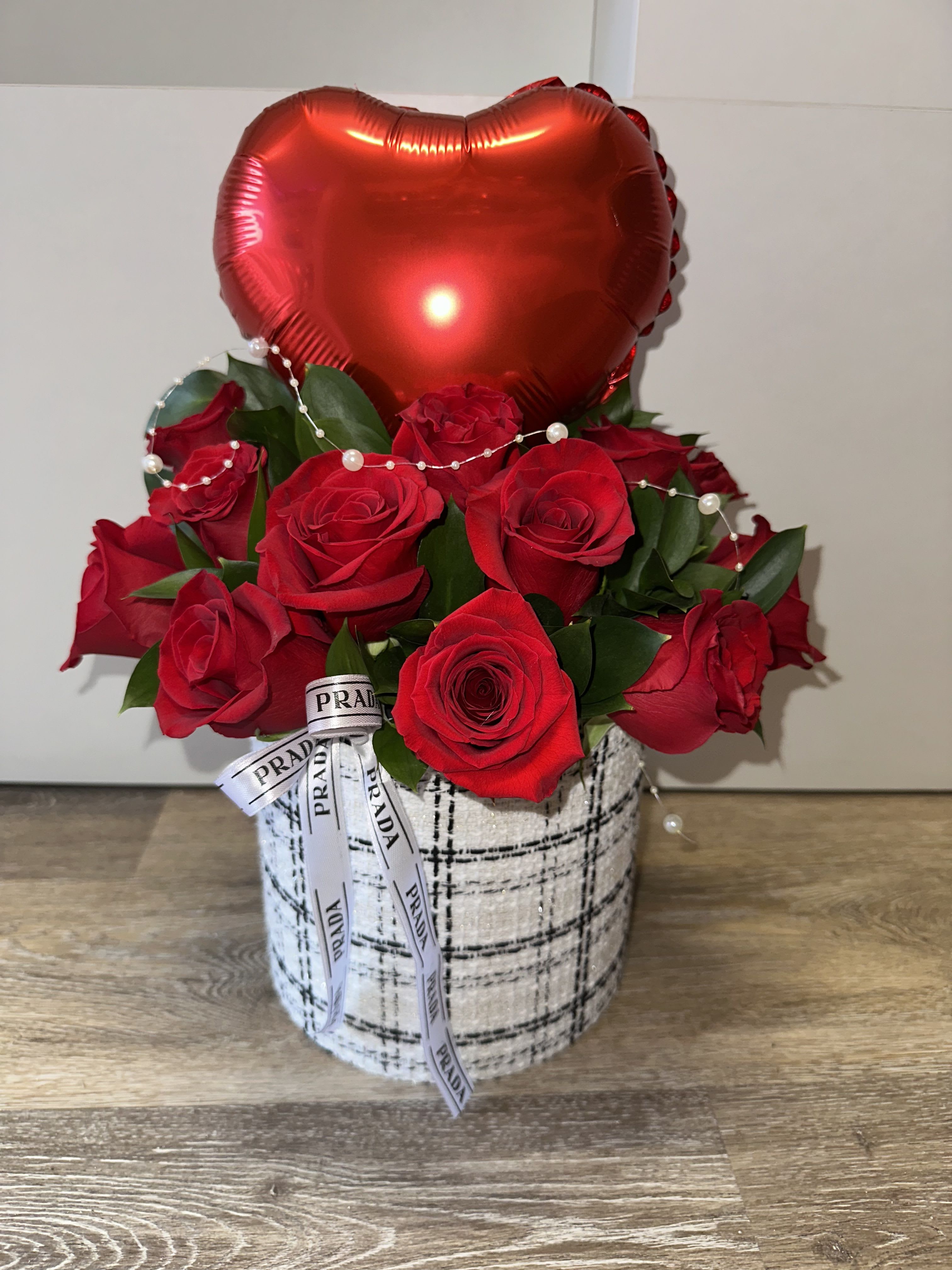 Red roses in a patterned box with a red heart balloon