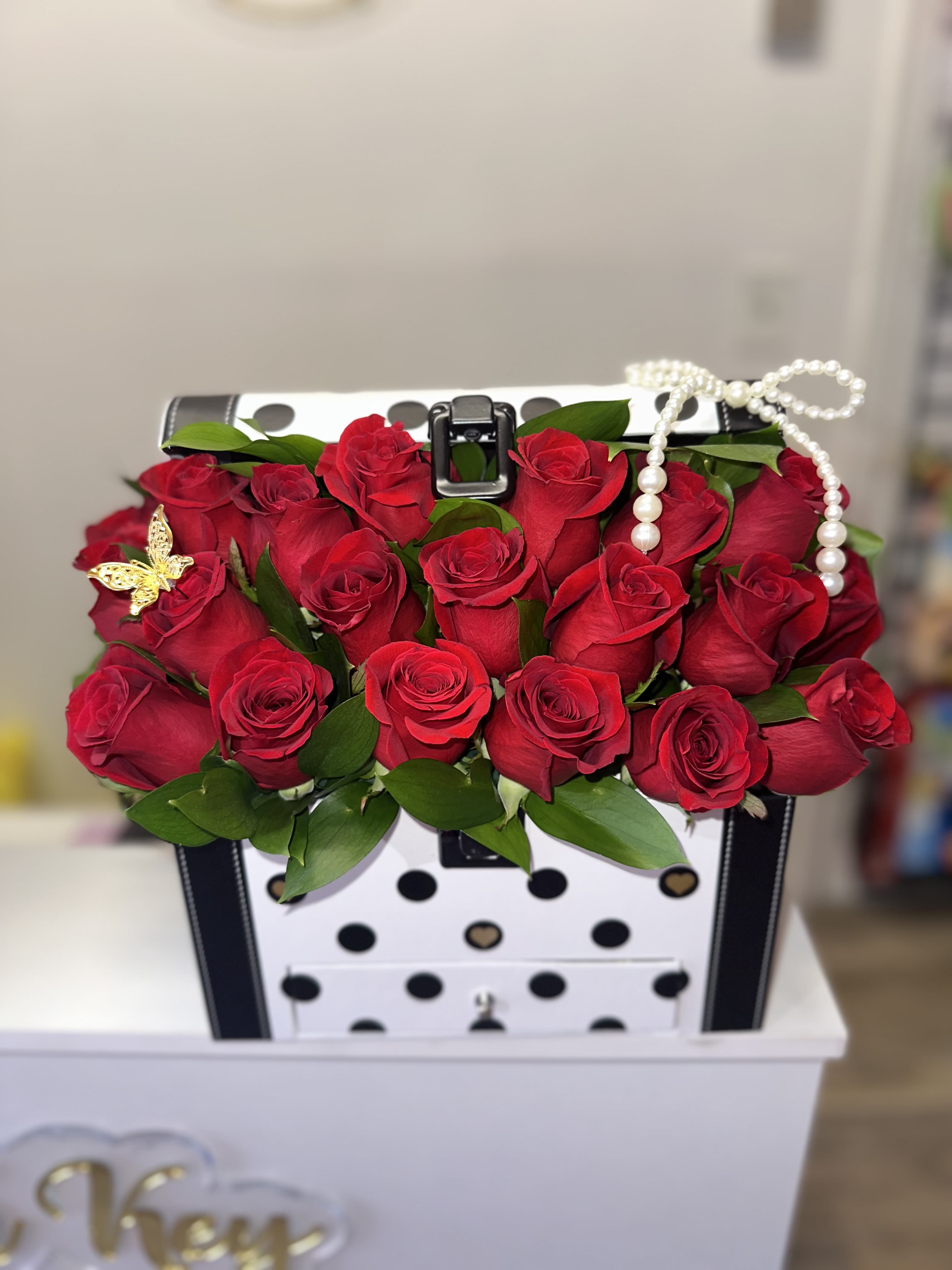 Red rose arrangement in a polka-dot gift box with pearl trim