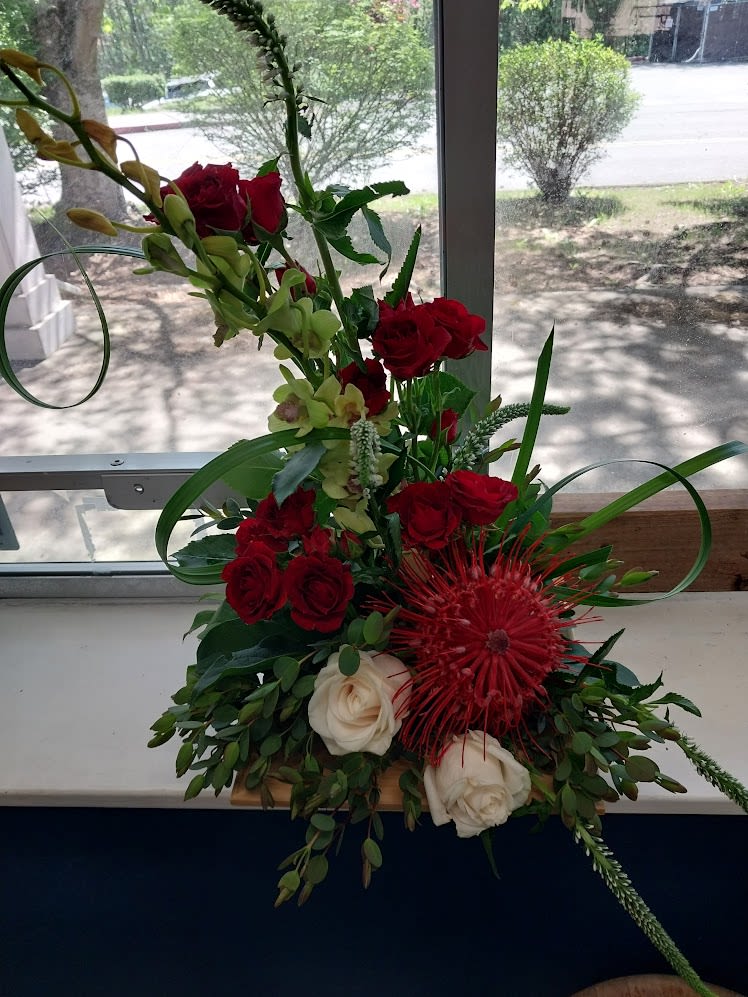Scarlet Symphony - A striking artistic design featuring roses, orchids, pincushion protea
