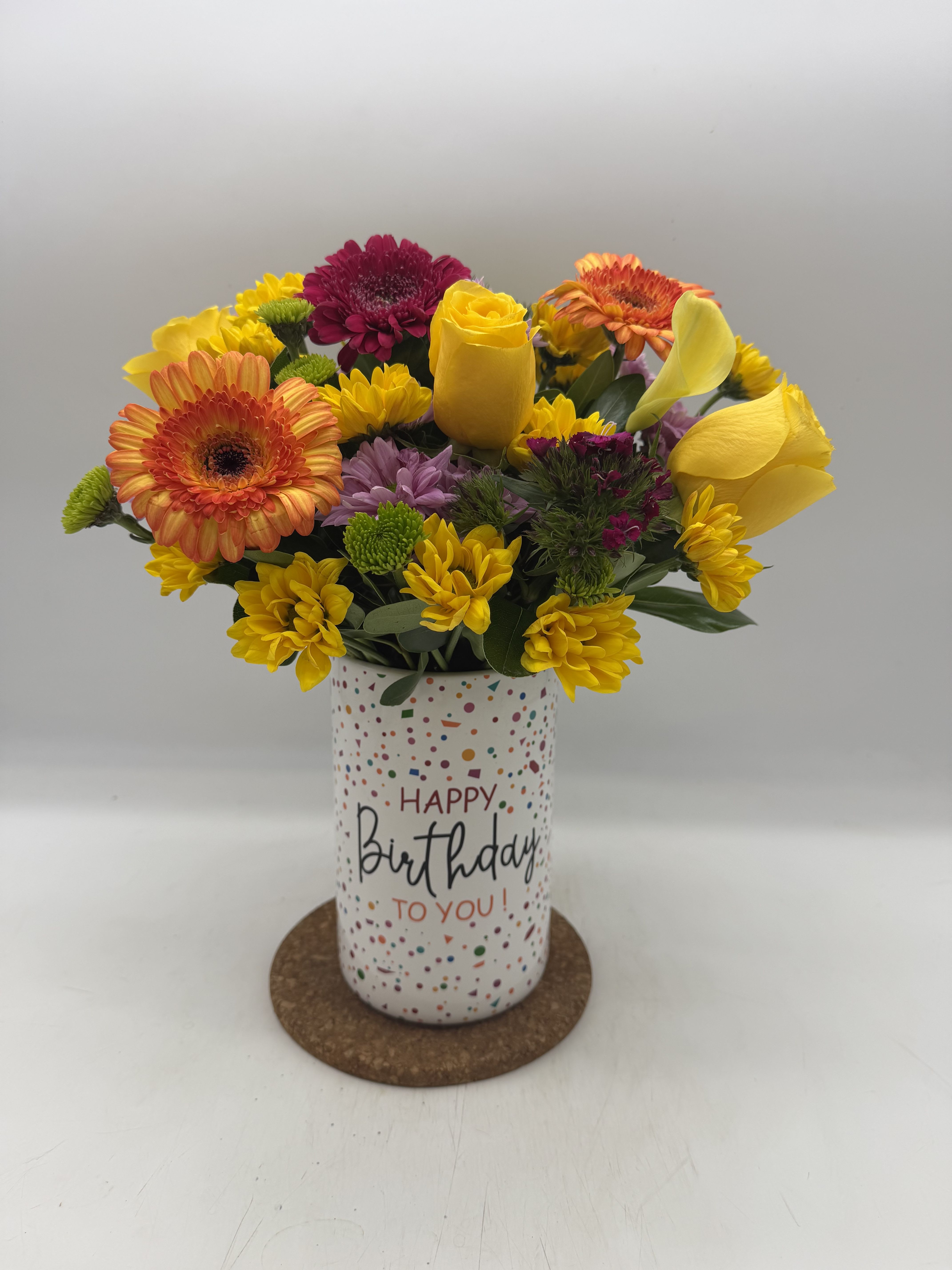Birthday Sprinkles  - It’'s true: sprinkles make everything better. Overflowing with roses, carnations, gerbera daisies and a glittering “Happy Birthday” pic, this handcrafted bouquet puts the cherry on top of any celebration. Good bouquet is approx. 12"H x 12"W. Better bouquet is approx. 13"H x 13"W. Best bouquet is approx. 14"H x 14"W. ( You can request this design using dfferent requested flowers) 