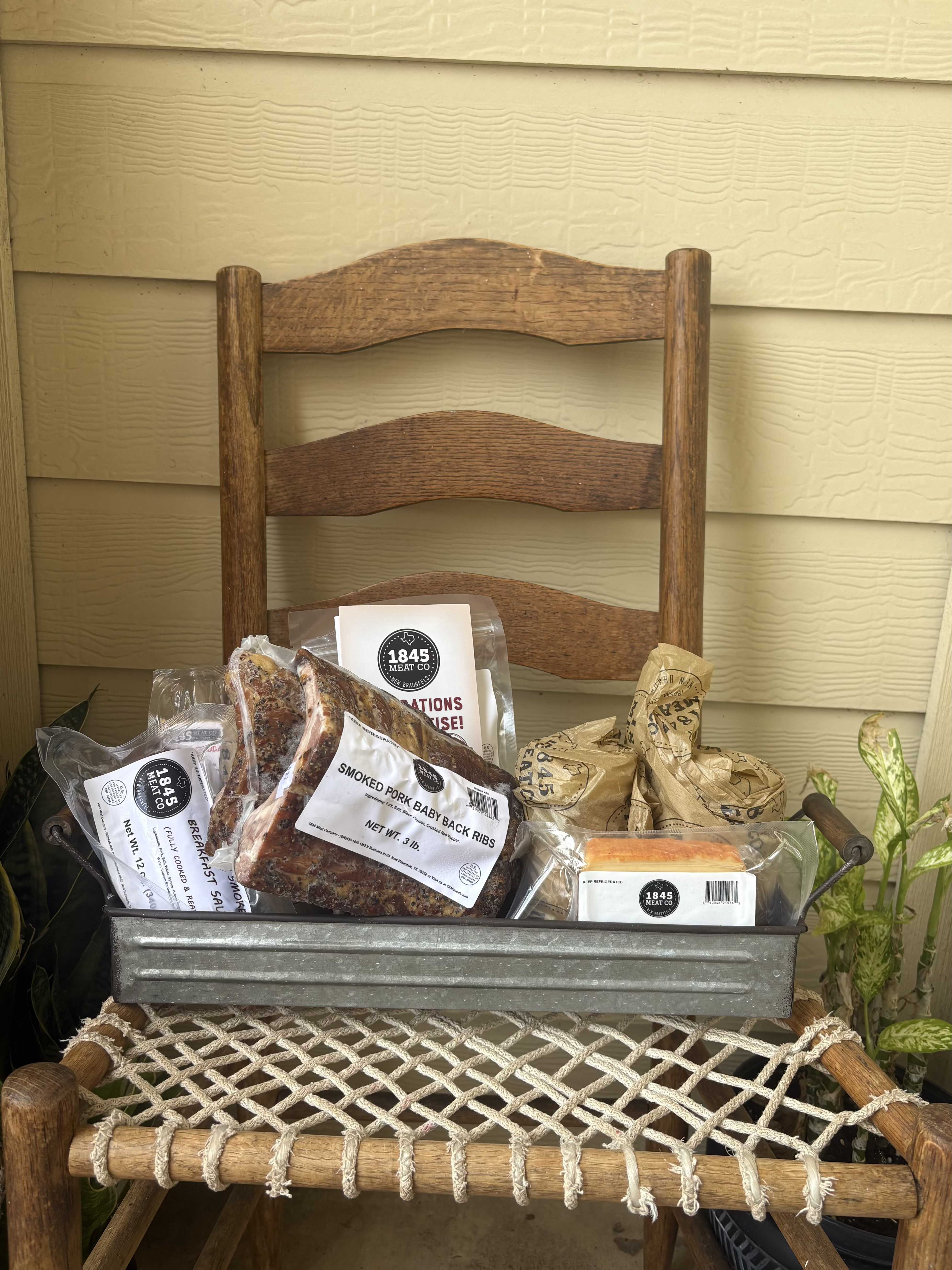 Back Porch Supper - A collection of Texas smokehouse favorites featuring ribs, artisan sausage, beef jerky, cheese, and savory pantry staples arranged in a rustic galvanized container. Perfect for Father's Day, birthdays, thank-yous, or anyone who appreciates good food and Texas flavor.