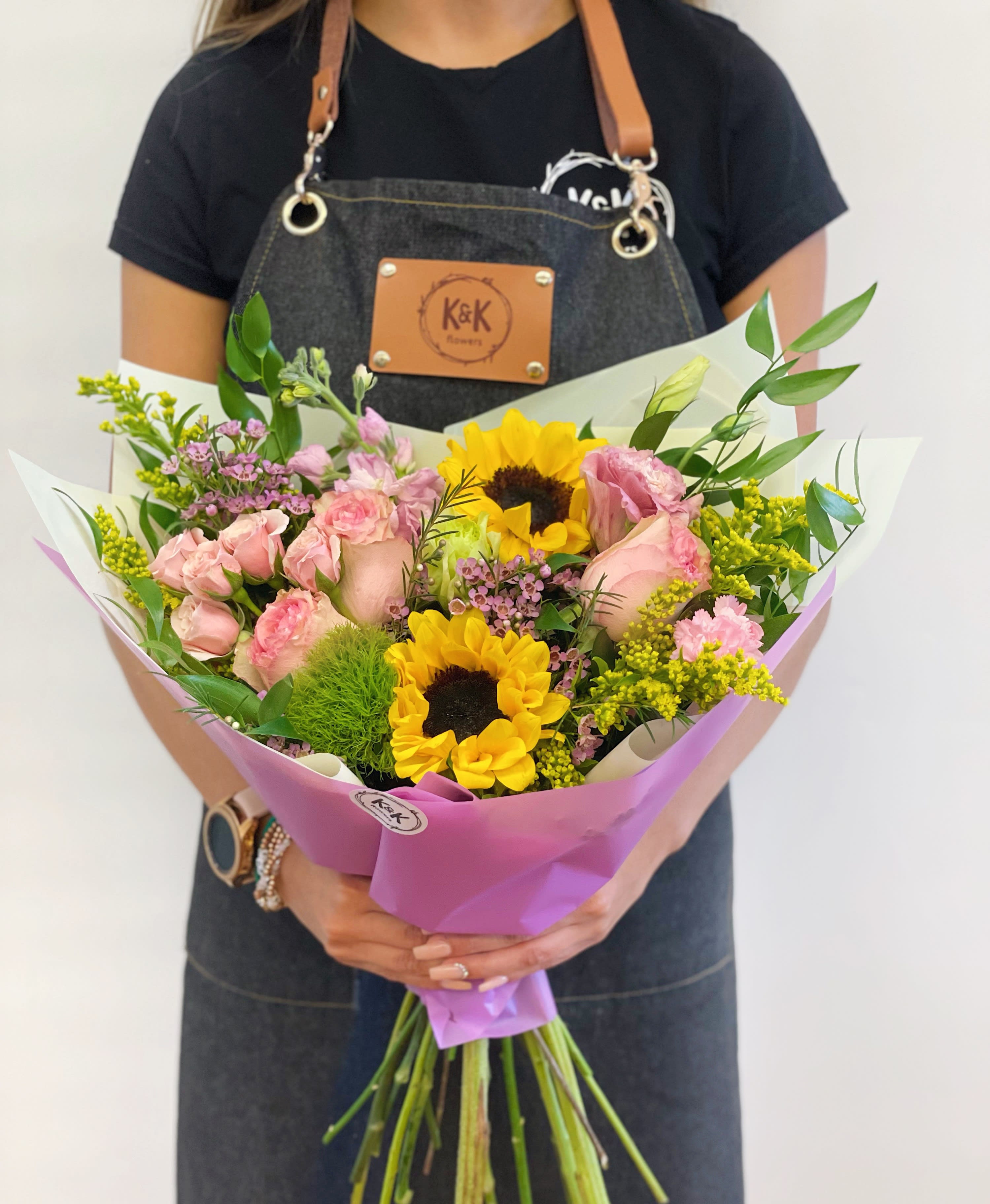 Loose bright bouquet small - Mixed flowers bouquet, from romantic and gentle to an edgy and interesting look. Bright mix of sunflowers, roses, spray roses, lisianthus and stock. Perfect for a Birthday, thank you or to cheer someone up on a rainy day.  All bouquets come without a vase. You can choose a vase at the add-on section