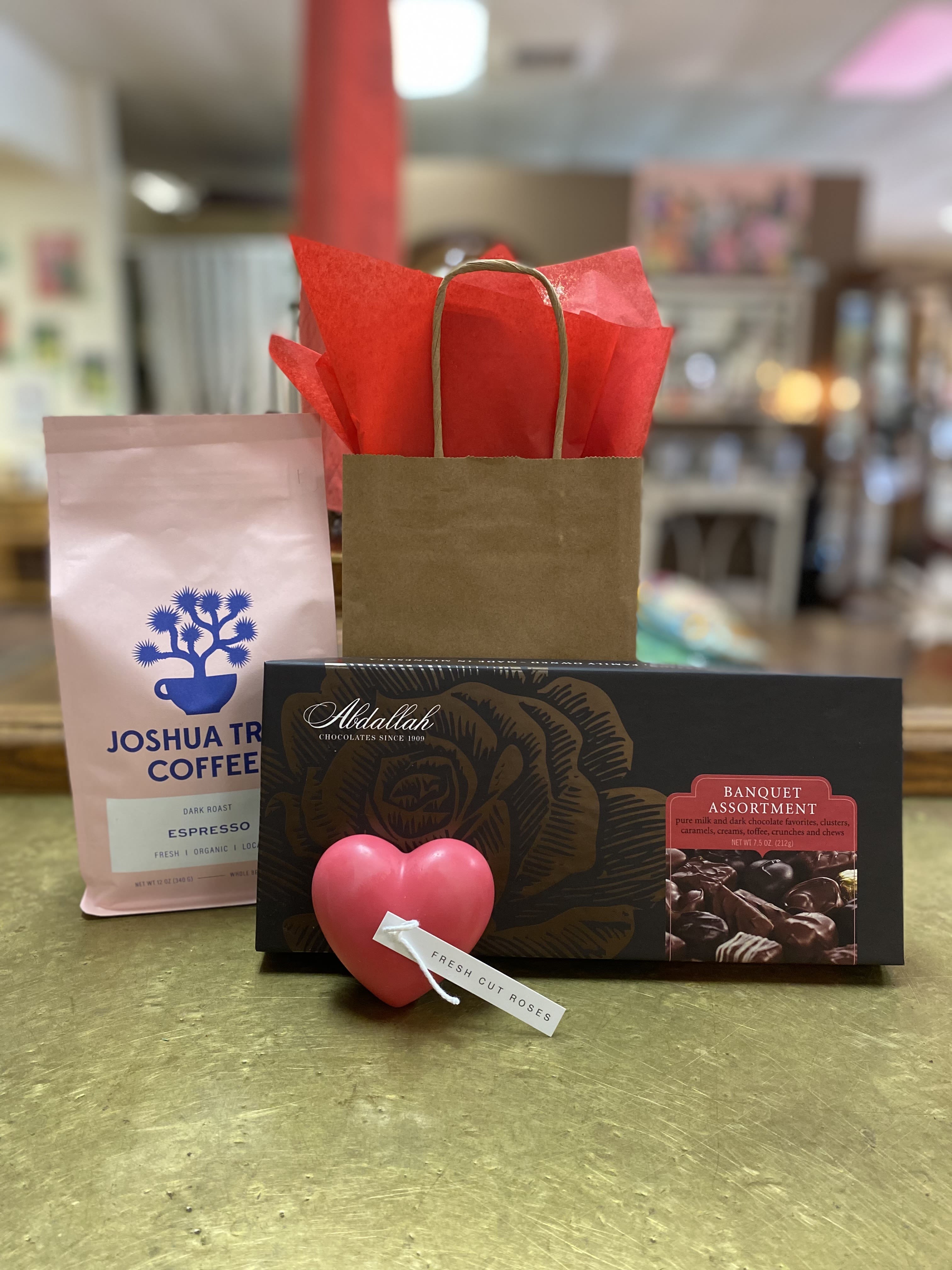 Gift set with coffee, chocolates, and a heart-shaped rose tag