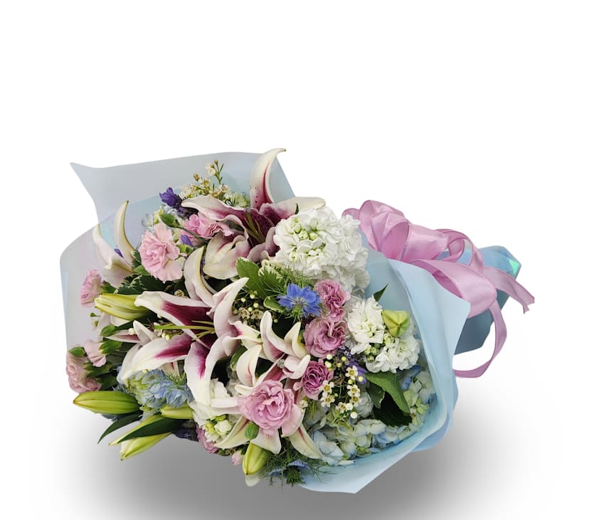 Scented Elegance Cello - Soft, sweet, and full of charm, the Scented Elegance bouquet features fragrant stargazer lilies, pink roses, lisianthus, and white stock, all beautifully wrapped in pastel blue paper and tied with a pink ribbon. Lightly scented with a sweet floral fragrance, it’s perfect for celebrations, romantic gestures, or simply saying thank you. This wrapped bouquet comes with its stems secured in a moist sponge to keep them fresh for a few hours, but it should be placed in water as soon as possible.