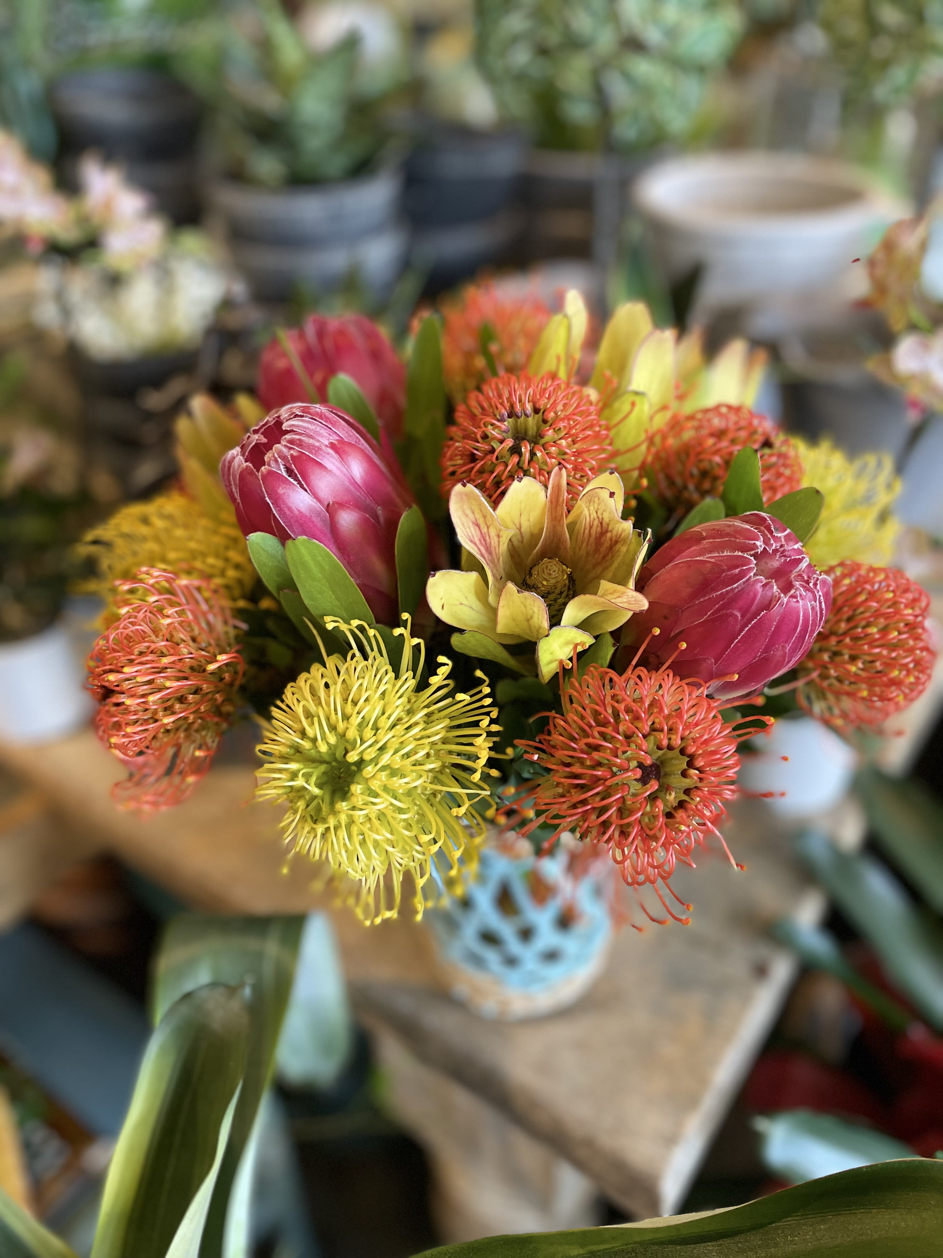 Bouquet of pink protea and yellow-orange pincushion flowers
