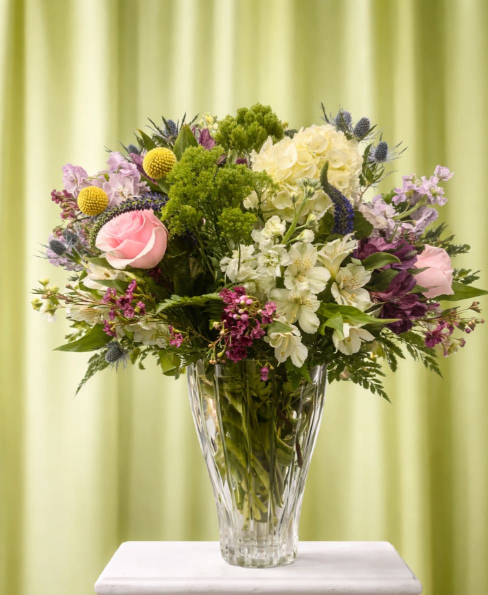 Simply elegant - Soft pink roses and creamy white hydrangea create a gentle, refined centerpiece that feels both celebratory and sincerely thoughtful - perfect as a birthday bouquet, a thank-you arrangement, or a springtime gift. The person you're sending this to will notice the garden-style fullness and airy lift, a look that reads as polished without feeling formal.  This flower arrangement pairs roses, hydrangeas, and white alstroemeria with small purple and yellow accent blooms for a cheerful contrast. The mix is arranged in a clear glass vase that lets the stems show and keeps the composition feeling fresh and natural; blooms extend outward in a rounded, balanced design that looks full from every angle. Colors include soft pink, white, purple, and bright yellow, giving a pleasing range of tones that suits many recipients and occasions.  Ideal for someone who deserves to feel seen and celebrated, this arrangement sends a message of warmth and appreciation without being over the top. It arrives ready to display in its vase; to prolong enjoyment, keep the water fresh and trim stems every few days.   If any design elements are of major importance to your order, please include them in the florist instructions at checkout or contact us to ensure availability.