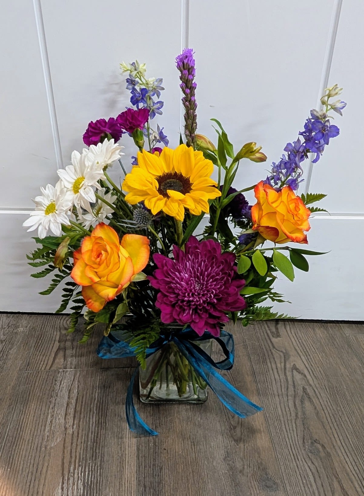 Keep Smiling - Glass vase includes Roses, Mums, Sunflower, Daisies, Larkspur, carnations and a variety of greens