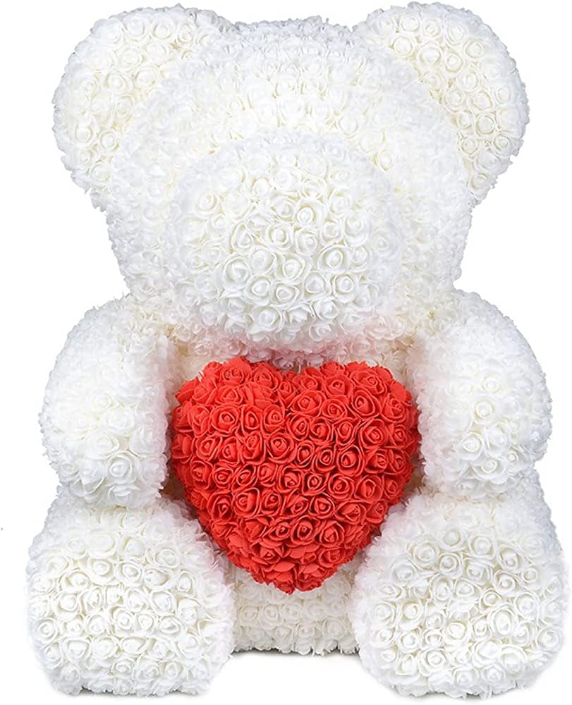 White teddy bear holding a red heart made of roses