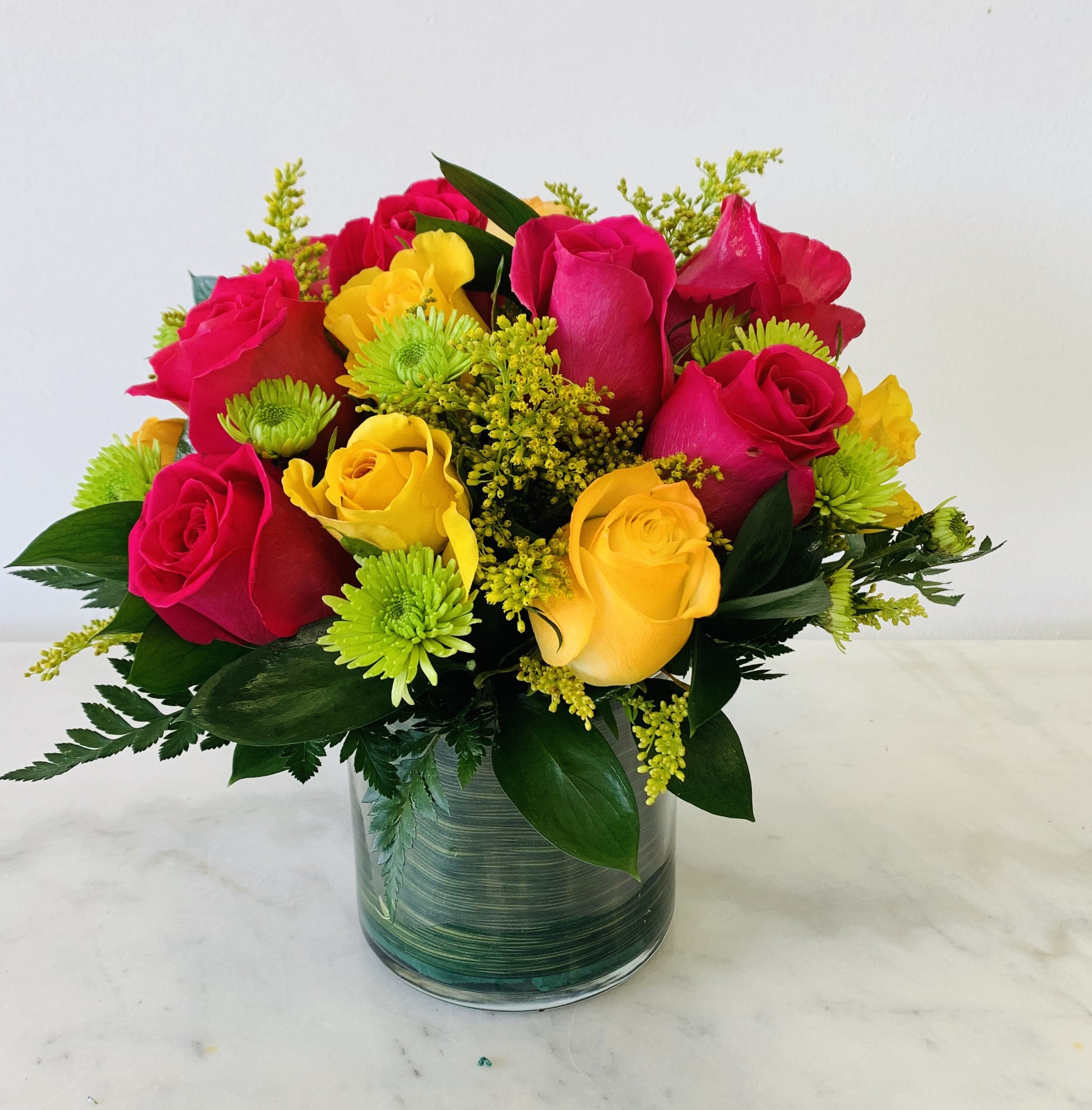 Bouquet of red and yellow roses in a glass vase