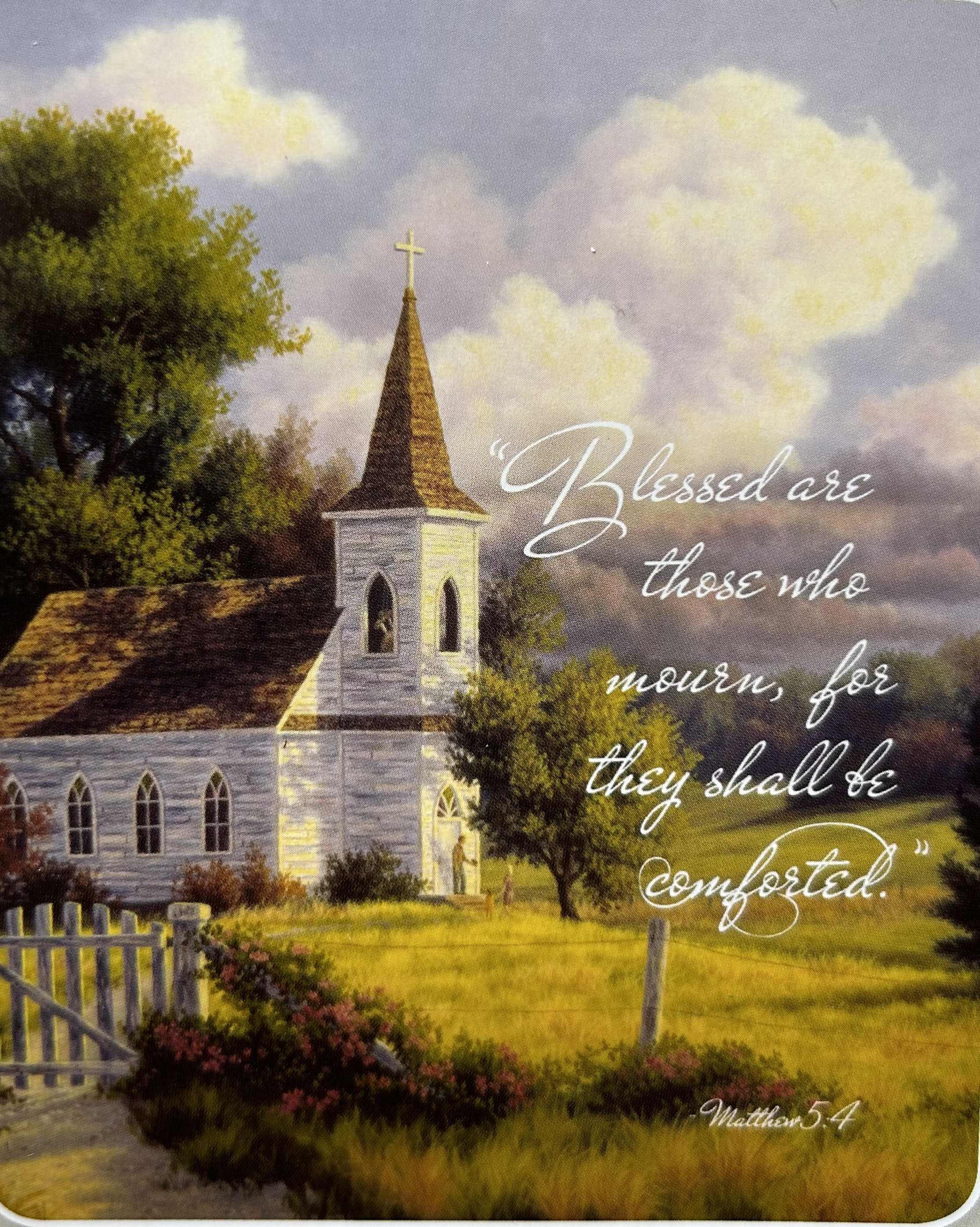 A church with a steeple and a Bible verse over a pastoral landscape