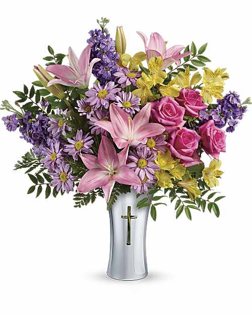Bright Life Bouquet - At once radiant and reverent, this colorful bouquet of roses, lilies and alstroemeria is beautifully arranged in a ceramic, silver-finished vase with a cross cut-out - a touching tribute to a bright life and your unending support. This glorious arrangement includes hot pink roses, pink Asiatic lilies, yellow alstroemeria, lavender stock, lavender daisy spray chrysanthemums, huckleberry, and leatherleaf fern. Delivered in a Shining Cross vase.
