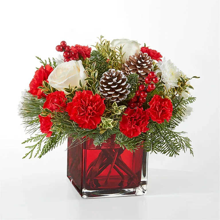 Christmas Market Flower -  Pet Friendly? NO — Red Roses are generally safe, but the bouquet contains pinecones and possibly other unknown seasonal accents. Keep out of reach; avoid homes with curious cats.   Human Allergy Note : No major allergy-triggering flowers noted. Keep bouquet in ventilated areas if sensitive to plant scents.   Care &amp; Longevity : Trim stems 1″ before placing in clean water. Replace water every 2–3 days. Avoid direct sun, heating vents, or drafty areas. Remove fading blooms promptly. Mist greenery lightly to maintain freshness.   Best Occasions &amp; Situations : - Holiday table centerpiece - Christmas gift - Winter home decor - Seasonal celebrations - Warm holiday greetings - Office or reception display - Festive dinner parties   Why Customers Love It : - Festive color palette perfect for holidays - Compact design fits tables and mantels - Fresh, hand-selected blooms - Gift-ready with minimal effort - Brings cozy seasonal vibes indoors