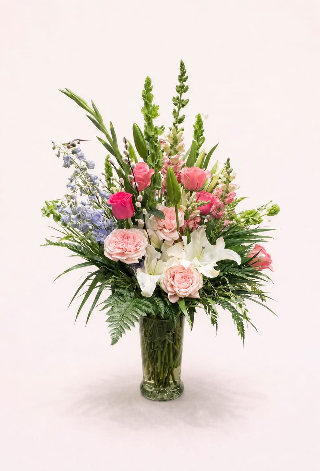 Grace In Bloom - Grace in Bloom is a lush garden-inspired arrangement featuring premium roses, fragrant lilies, delicate stock, and seasonal blooms artfully designed with fresh greenery.