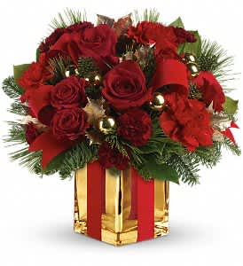 All Wrapped Up Bouquet by Teleflora - Lush red roses, fresh winter greens and a festive, gold mirrored glass cube are all wrapped up with red ribbon for an elegant, unforgettable gift!  This bouquet of deep red roses and spray roses, red carnations, maroon miniature carnations, green holly, noble fir, white pine and lemon leaf is dressed up with red velveteen ribbon and gold ornament balls. Delivered in a stunning gold Mirrored Cube vase.  Approximately 12 1/4" W x 11 3/4" H  Orientation: One-Sided  As Shown : TWR08-2A Deluxe : TWR08-2B Premium : TWR08-2C