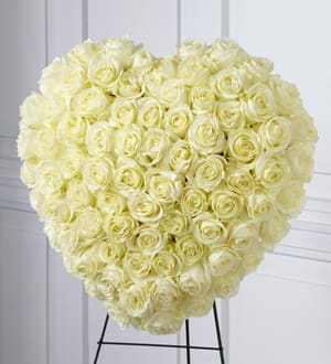 Heart-shaped bouquet of cream roses on a stand