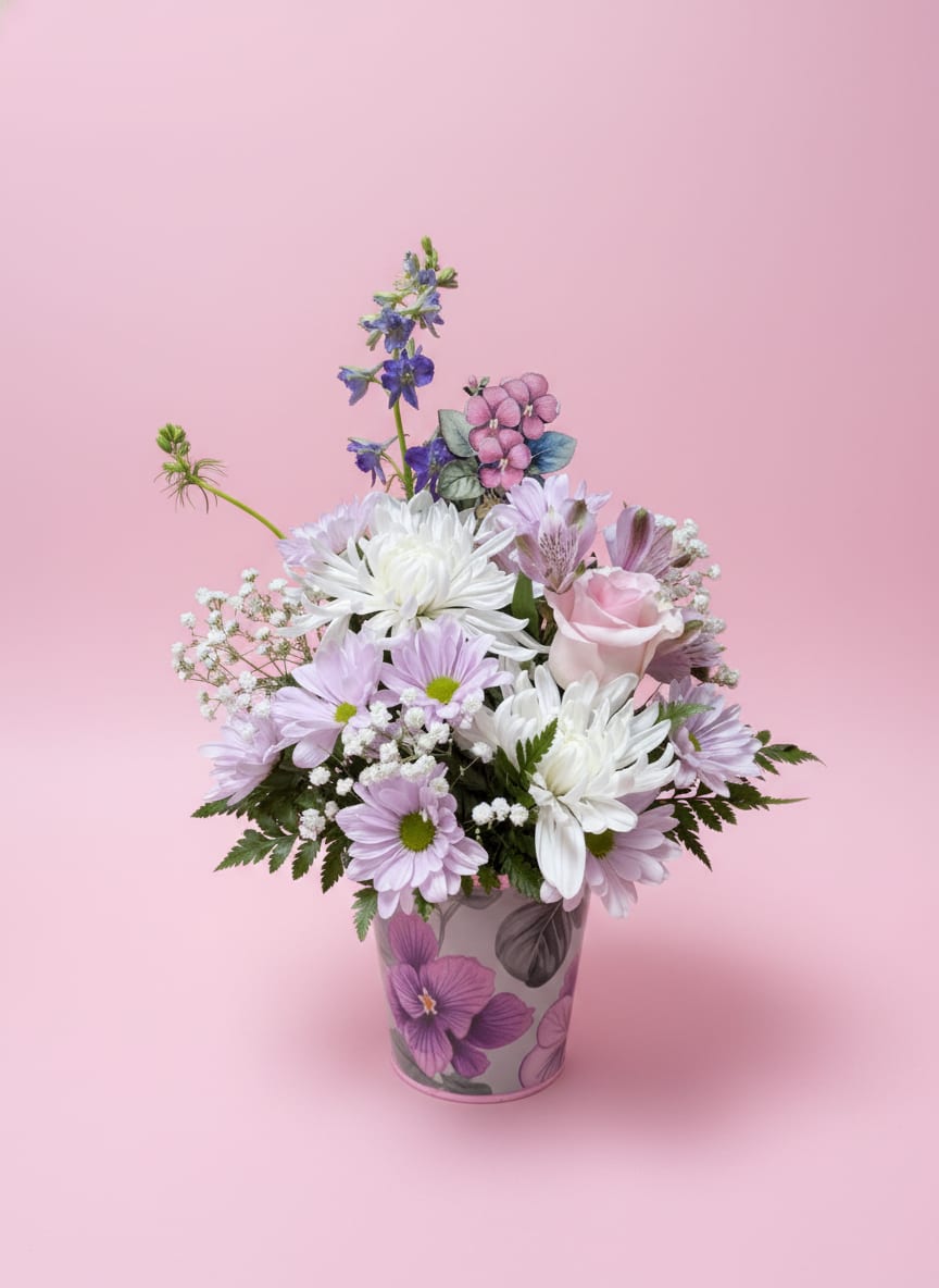 Pink and white mixed bouquet in a floral-patterned vase