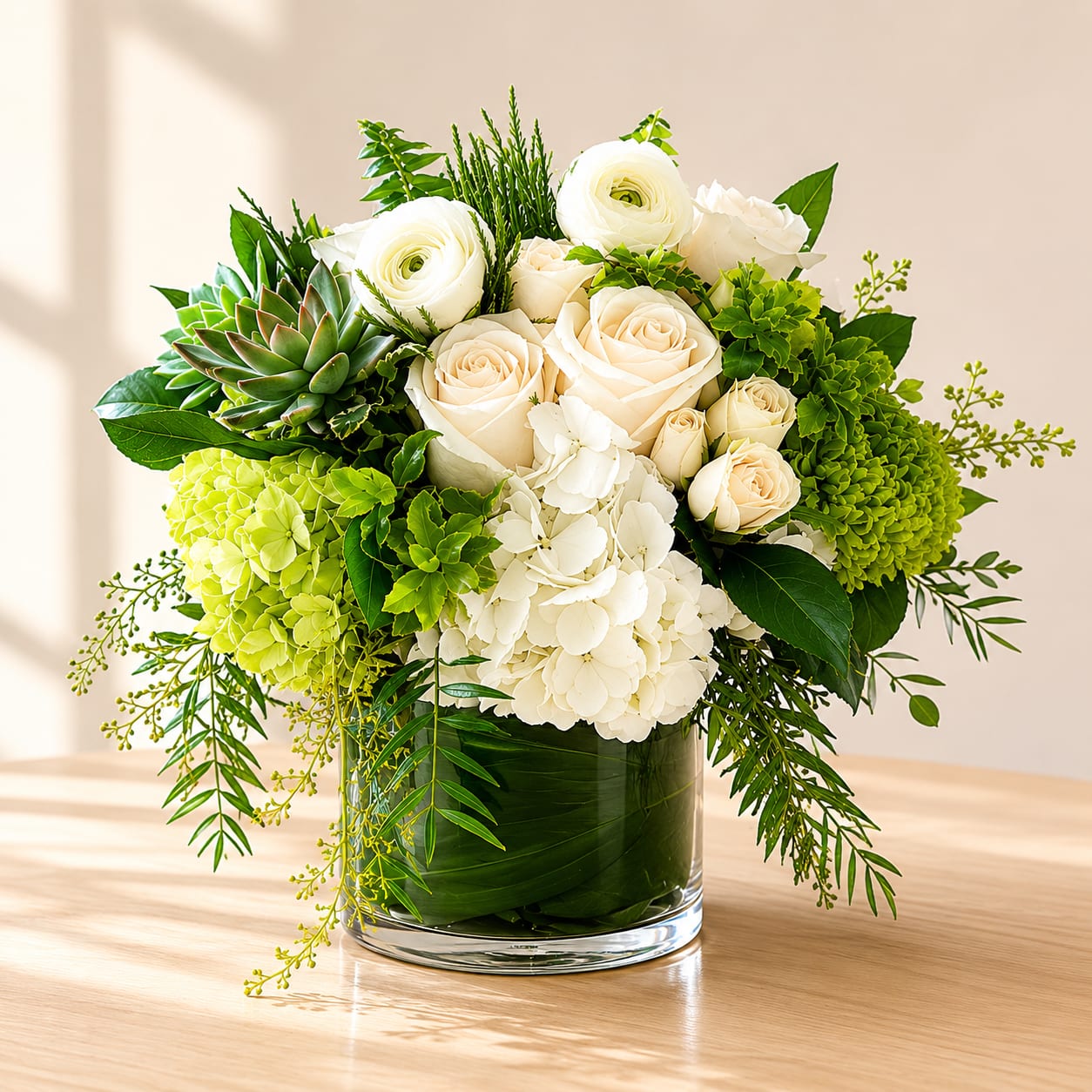 Secluded Garden - Introducing the Secluded Garden, where nature and creativity have united to craft a floral masterpiece that will leave you utterly enchanted! Picture this: a whimsical blend of white and green hydrangeas dancing together in perfect harmony, accompanied by delicate white seasonal florals, elegant roses, and charming spray roses. But wait, there's more! This garden wonderland also boasts lush green succulents, adding a touch of contemporary chicness to the mix. 