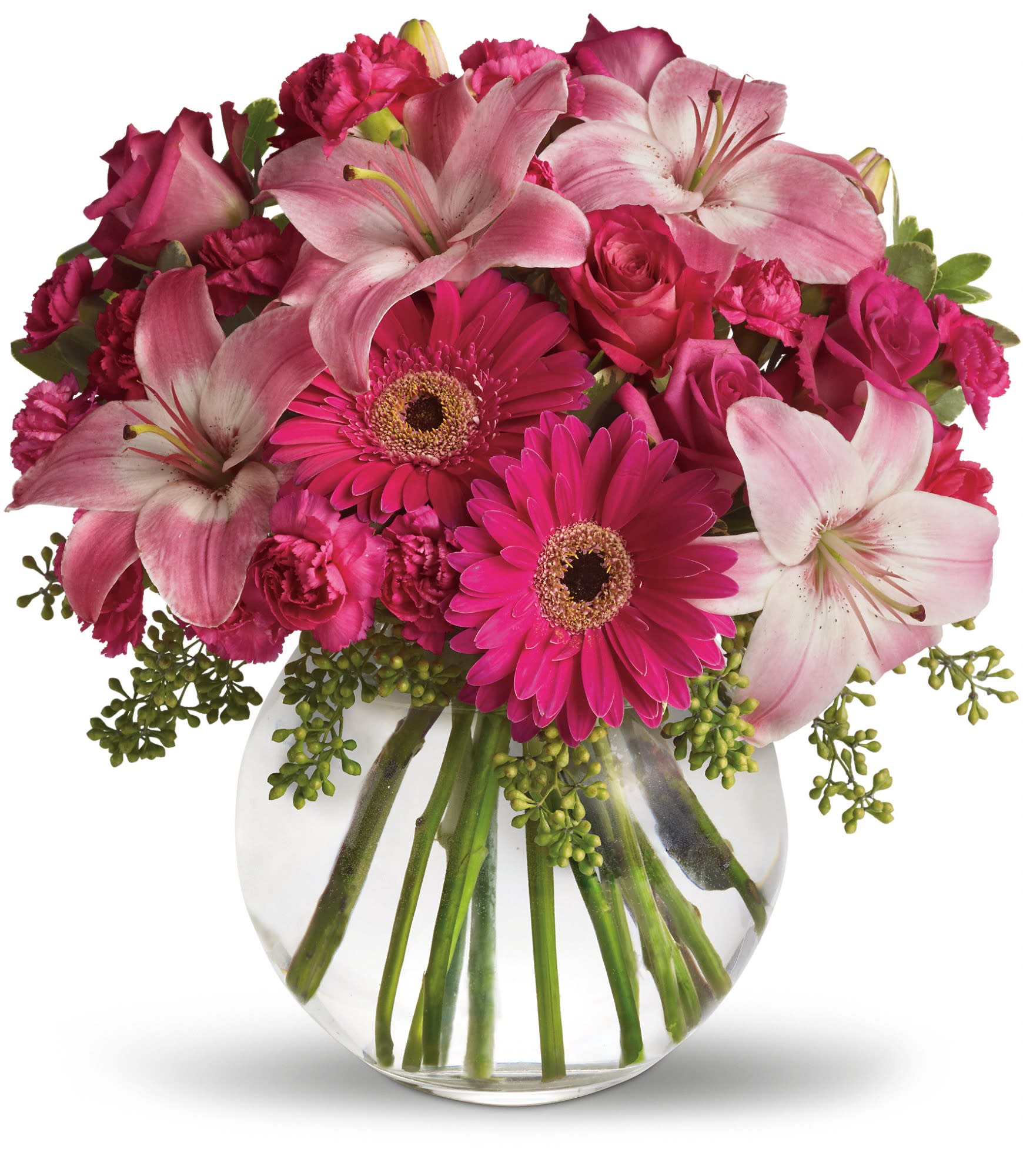 Pink lilies, gerbera daisies, roses, and carnations in a clear glass vase