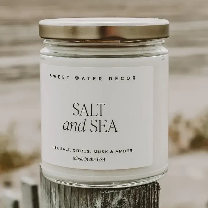 Sea And Salt Soy Candle - Crisp, clean, and endlessly refreshing, Salt and Sea is a sophisticated blend of citrus, sea salt, and musk with a subtle hint of clove. This modern coastal scent brings an effortless elegance to any space - perfect for customers who love fresh, airy fragrances that feel timeless year-round. A proven favorite for every season, Salt and Sea adds a refined coastal touch to any home collection.
