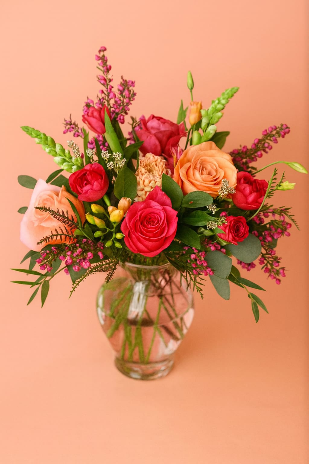 Radiant Mama! - Deluxe - Fuchsia  - Vibrant and full of heart, Radiant Mama bursts with fuchsia and soft pink roses, tulips, ranunculus, and pretty pink accents. Pick the perfect size for your perfectly radiant mom - whether a sweet splash or a bold bloom! Each arrangement will be carefully created to resemble the photo with a little natural uniqueness in every design.