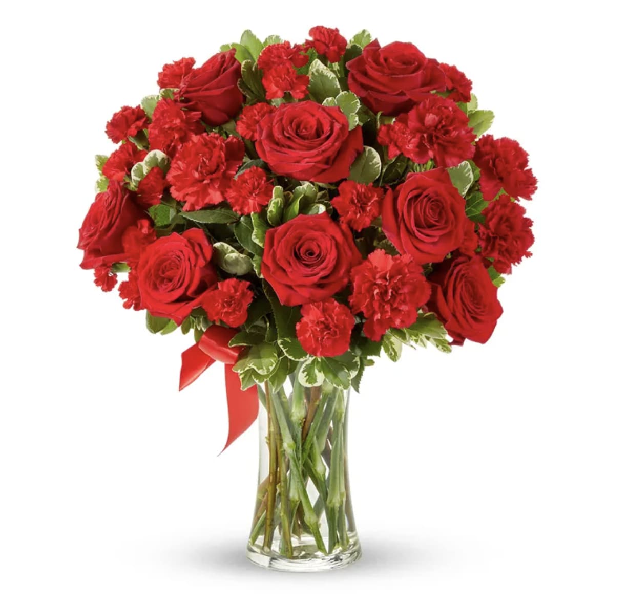 Red roses and carnations in a clear glass vase with a red ribbon